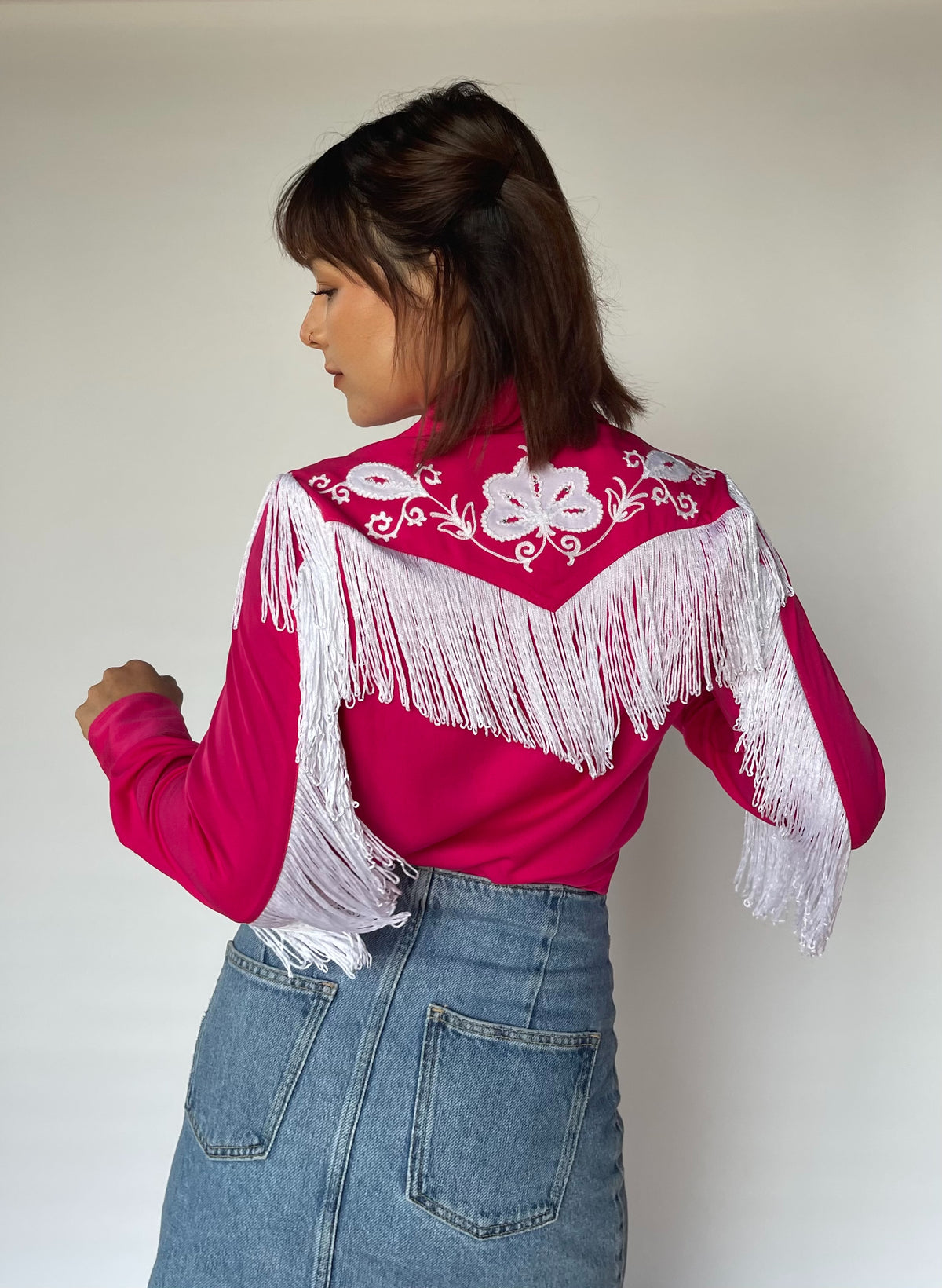 Back view of the H Bar C Taos women's pink western shirt with white fringe across the back yoke.