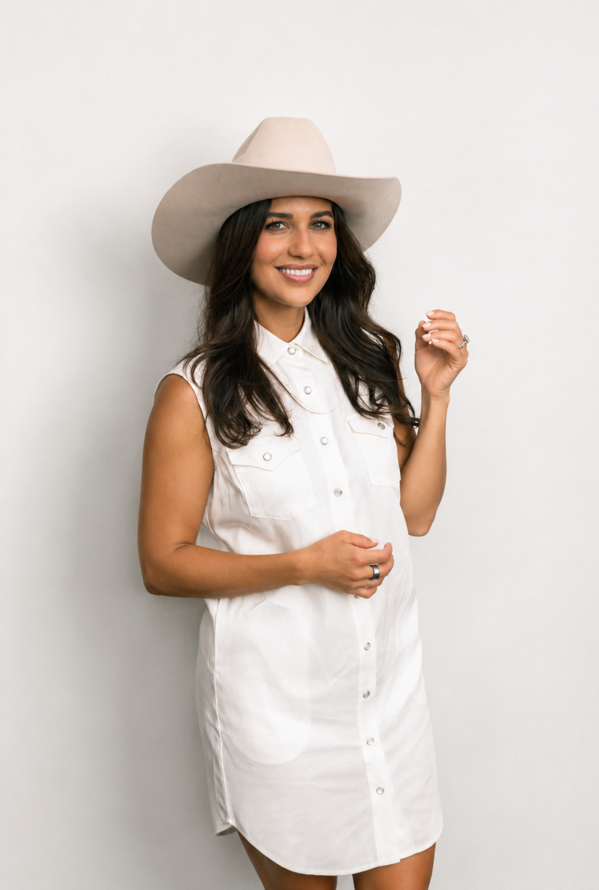 Woman in a cream cowboy hat wearing the H Bar C Palm Beach women's dress in white, a sleeveless western shirt dress.