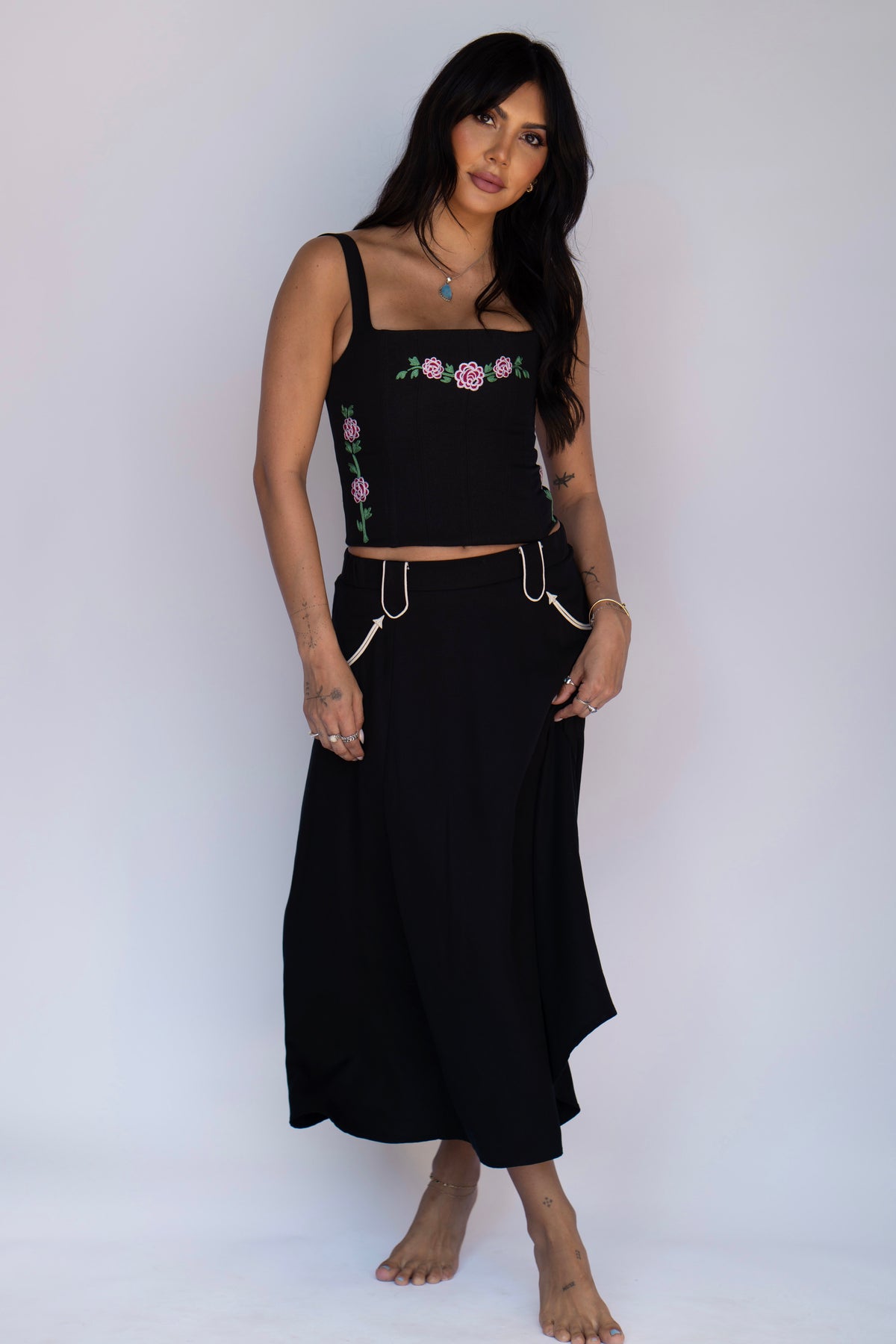 Front view of the H Bar C Santa Fe black western skirt with white piped pockets, banded waist, and below-the-knee length.