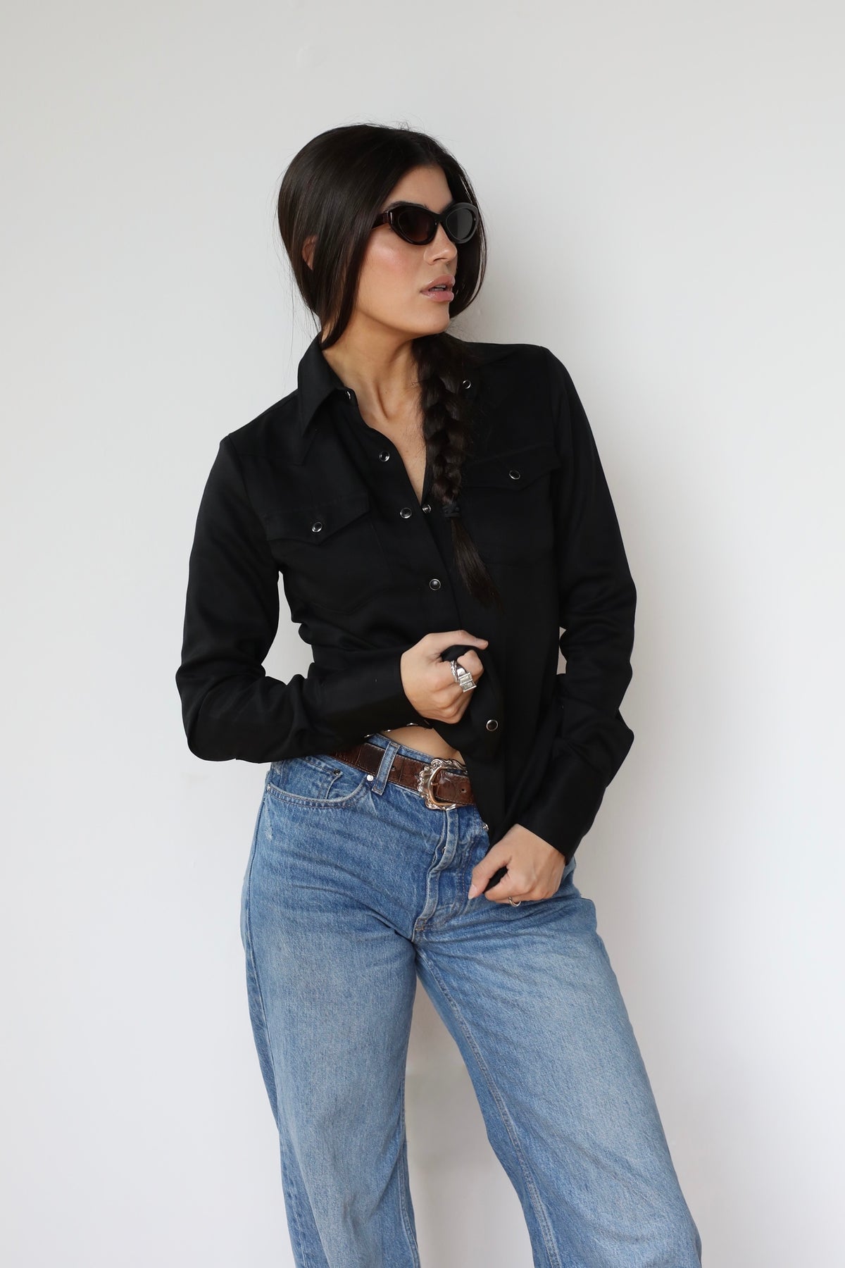 Woman in sunglasses wearing the H Bar C Denver black women's western shirt with light jeans.