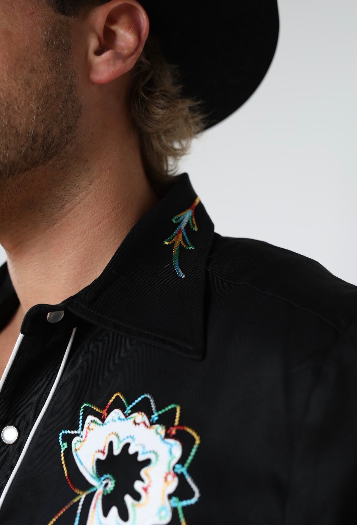 Collar detail of the H Bar C Texas black western shirt with floral embroidery.