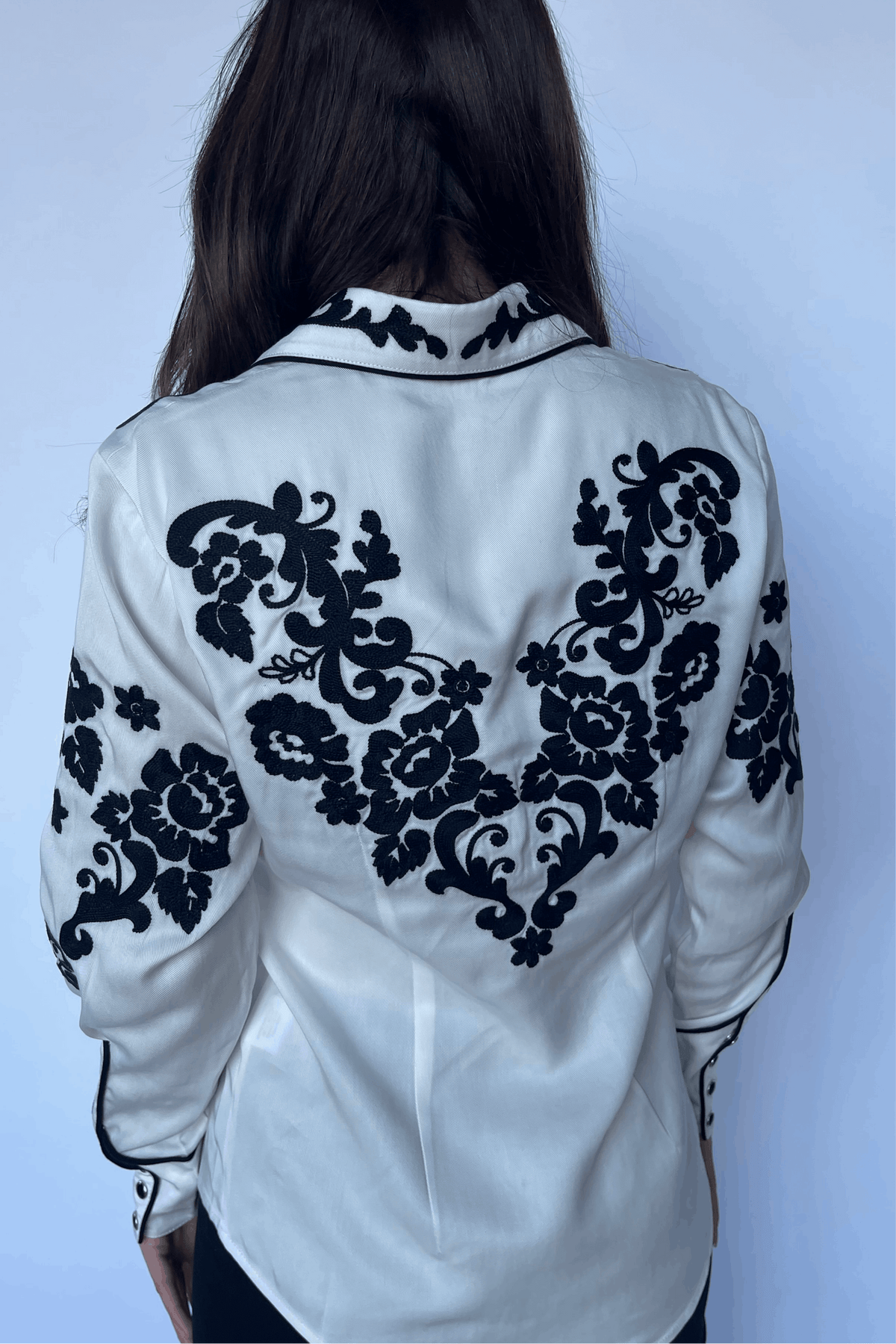 Back view of the H Bar C Fort Worth white shirt covered in black chain stitch rose embroidery.