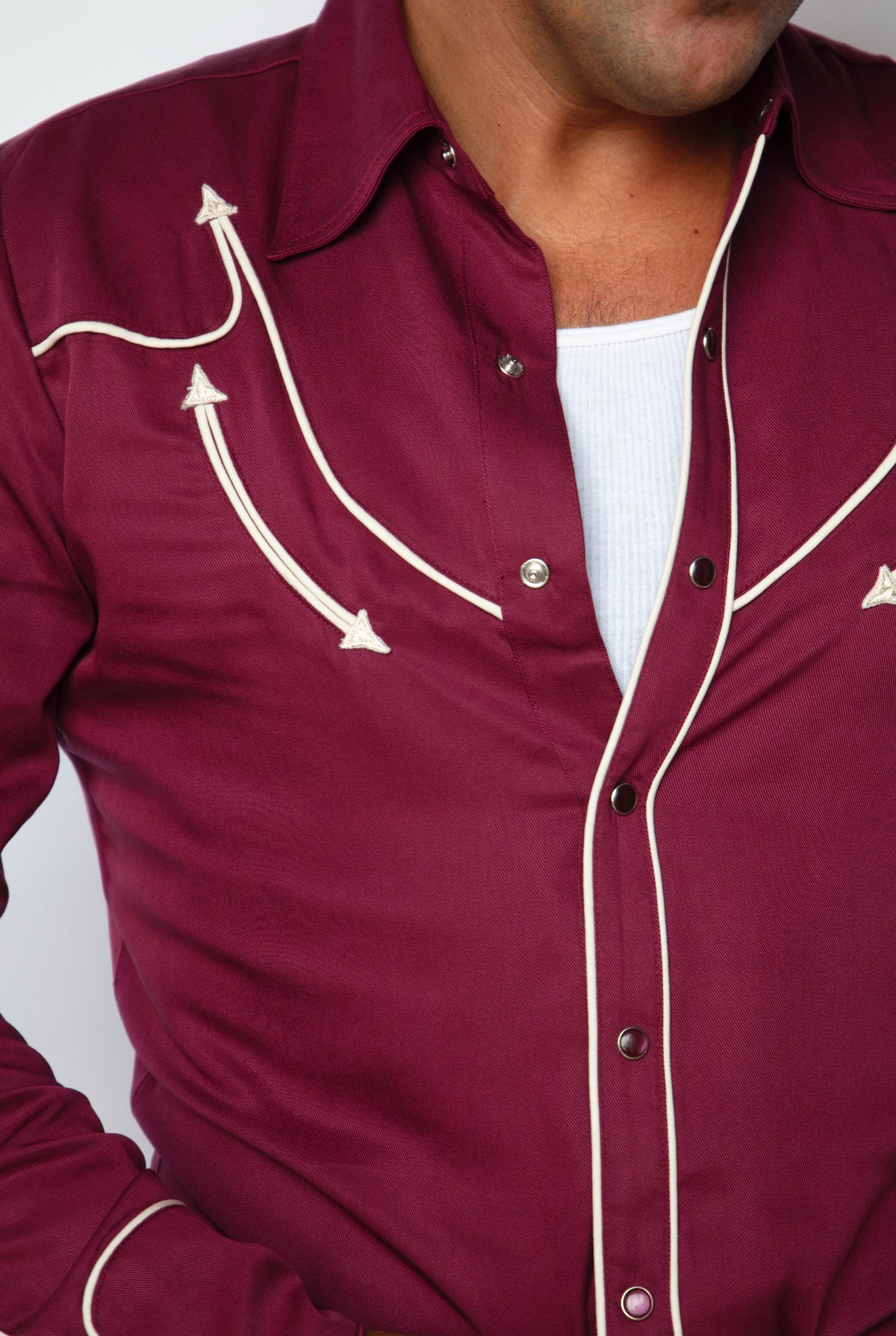 Close-up of the off white arrow embroidery on the H Bar C Reno maroon shirt.