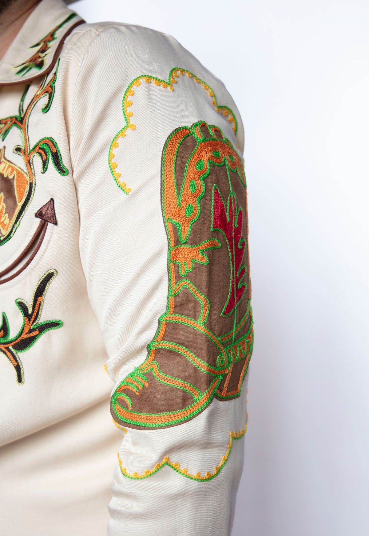 Sleeve detail of the H Bar C Calabasas shirt showing a chain stitch embroidered cowboy boot on off-white Tencel.