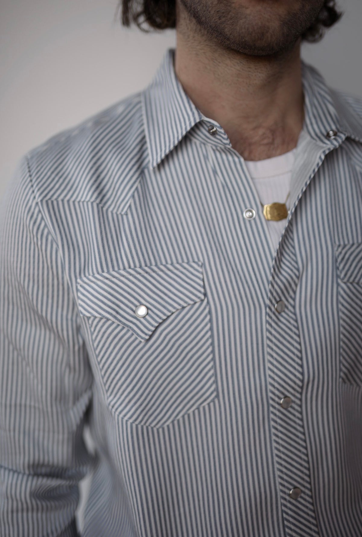Close-up of the pocket flap and pearl snaps on the H Bar C Folsom blue stripe shirt.
