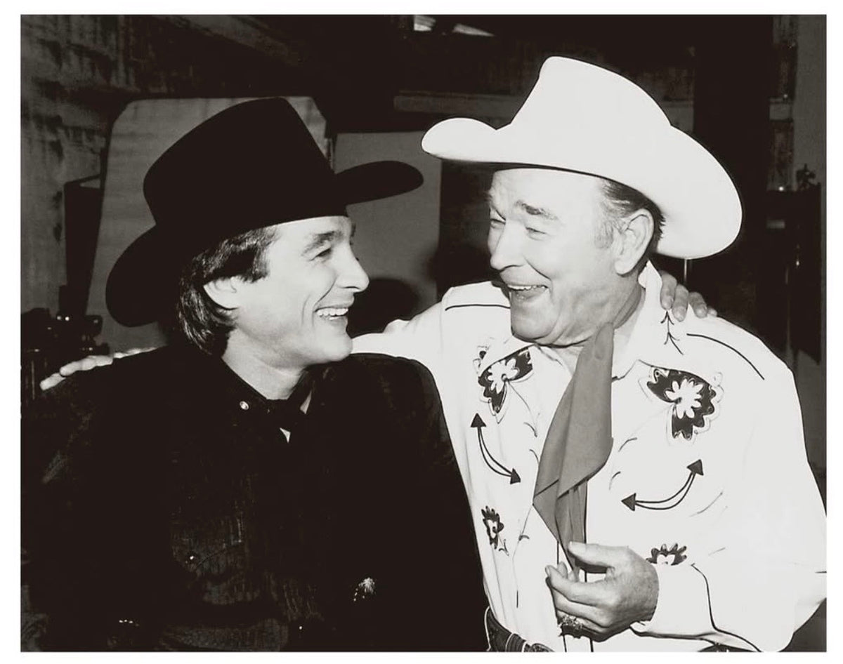 Archival black and white photo of two men in cowboy hats and embroidered western shirts, H Bar C Texas shirt heritage.