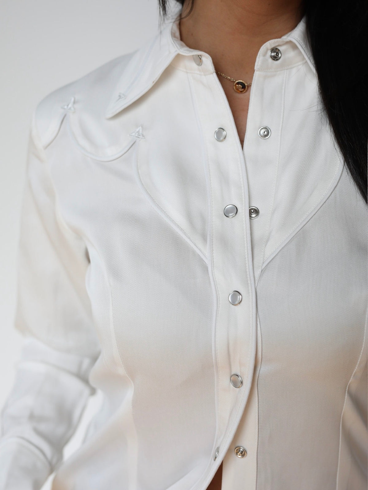 Close-up of the white piped yoke and pearl snap placket on the H Bar C Lake Tahoe women's white western shirt.