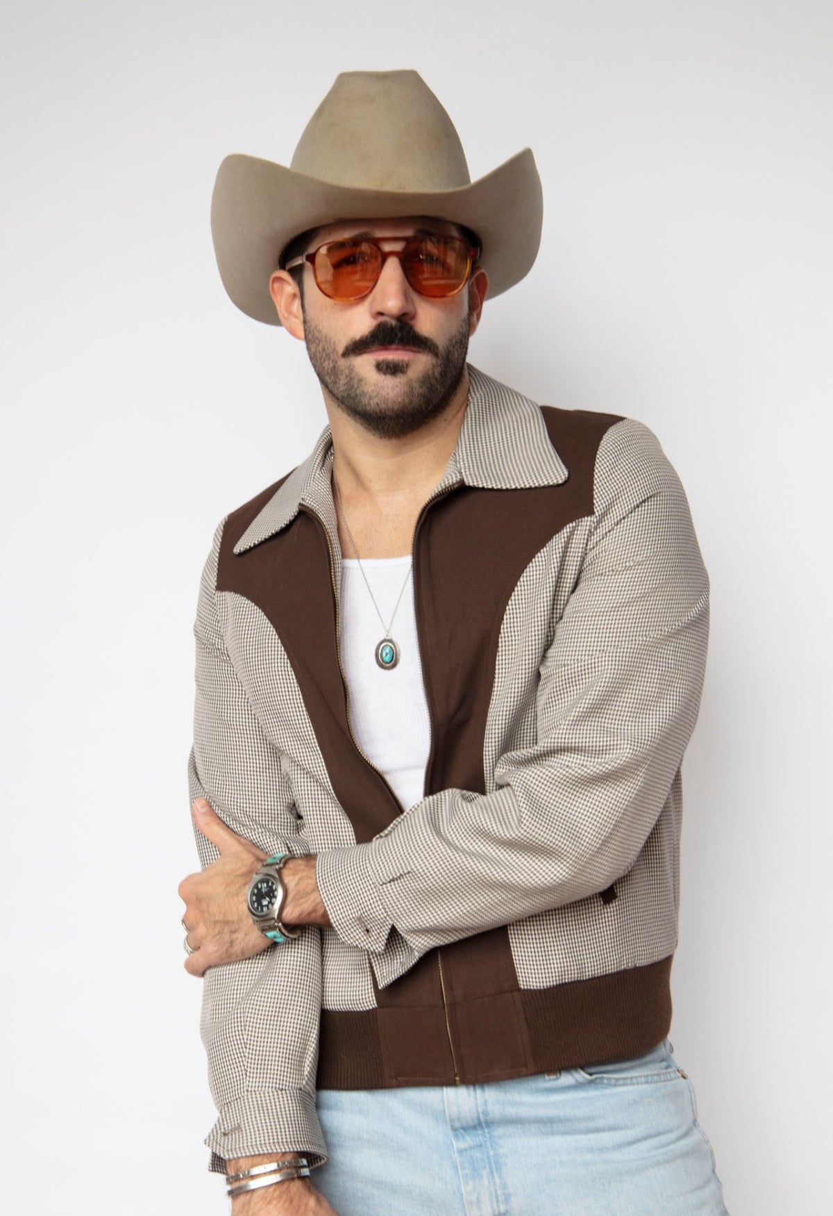 Man in tinted glasses wearing the H Bar C Kentucky espresso houndstooth zip jacket.