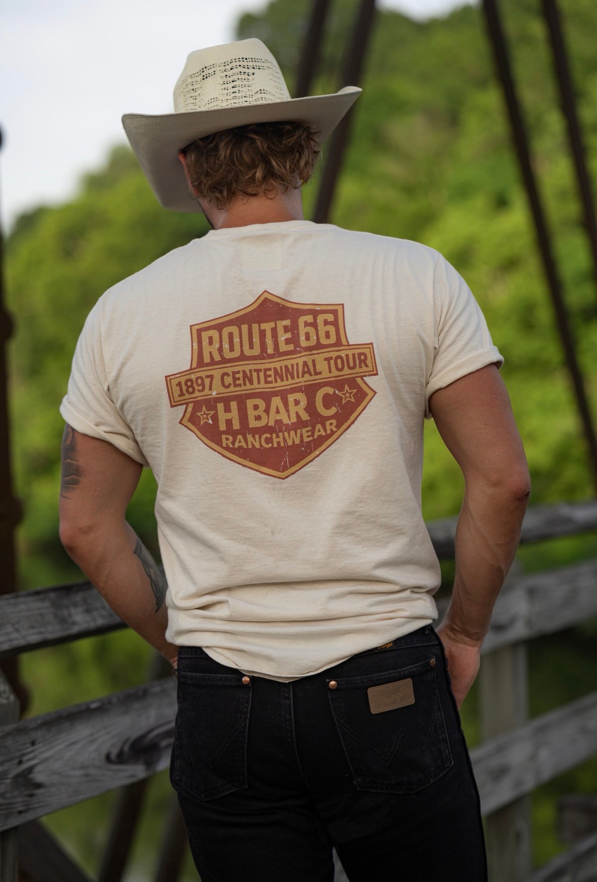 Close-up of the orange Route 66 Centennial shield print on the back of the cream H Bar C Tulsa Shield tee.