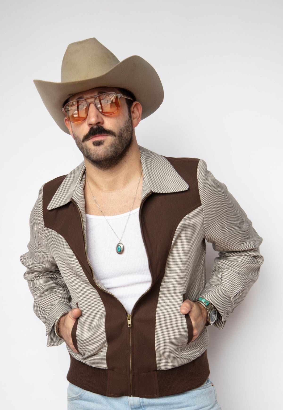 Front view of the H Bar C Kentucky espresso jacket worn open over a white tank with a cowboy hat.