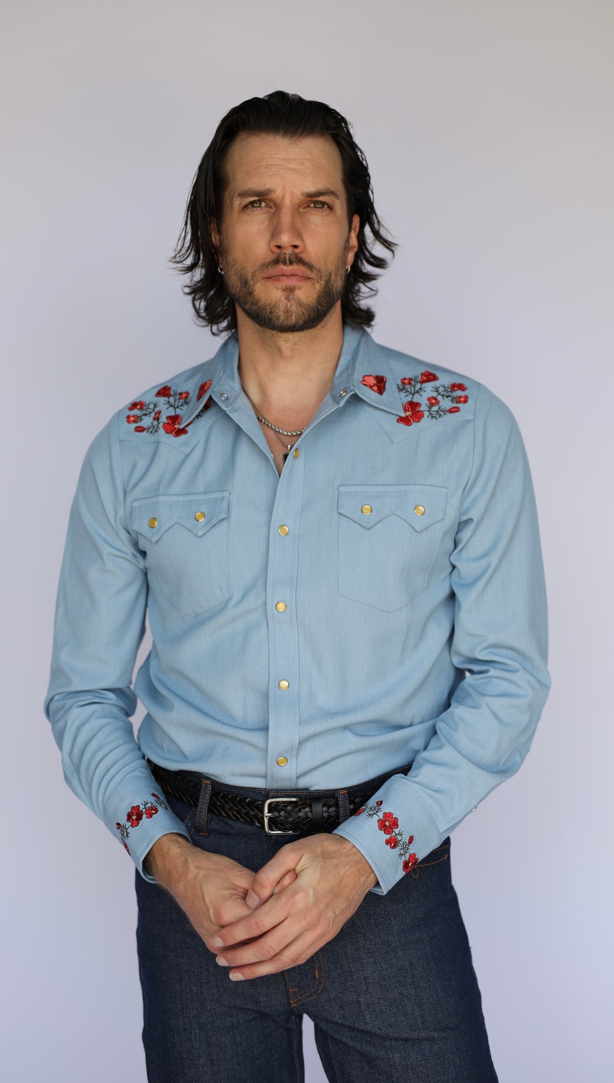 Front view of the HBarC x Gibson Dove chambray western shirt with red poppy embroidery on shoulders and cuffs, a Gibson Guitar collaboration.