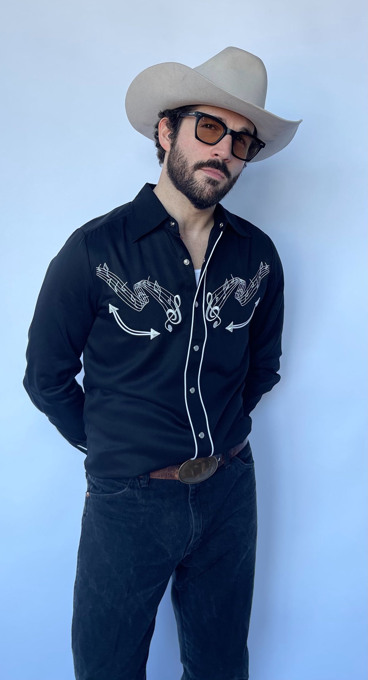 Three-quarter view of the H Bar C Nashville black shirt with white embroidery and piping.