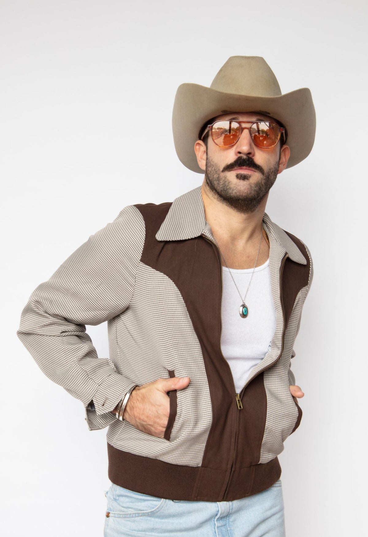 Three-quarter view of the H Bar C Kentucky espresso jacket with hands in pockets.