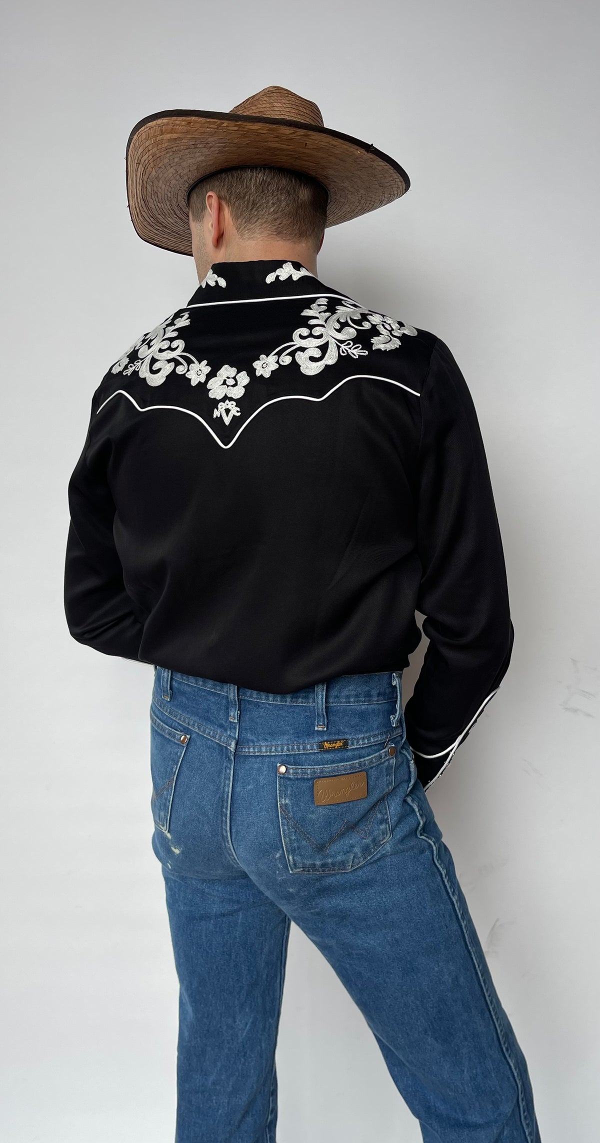 Full back view of the H Bar C Durango black embroidered shirt tucked into jeans.