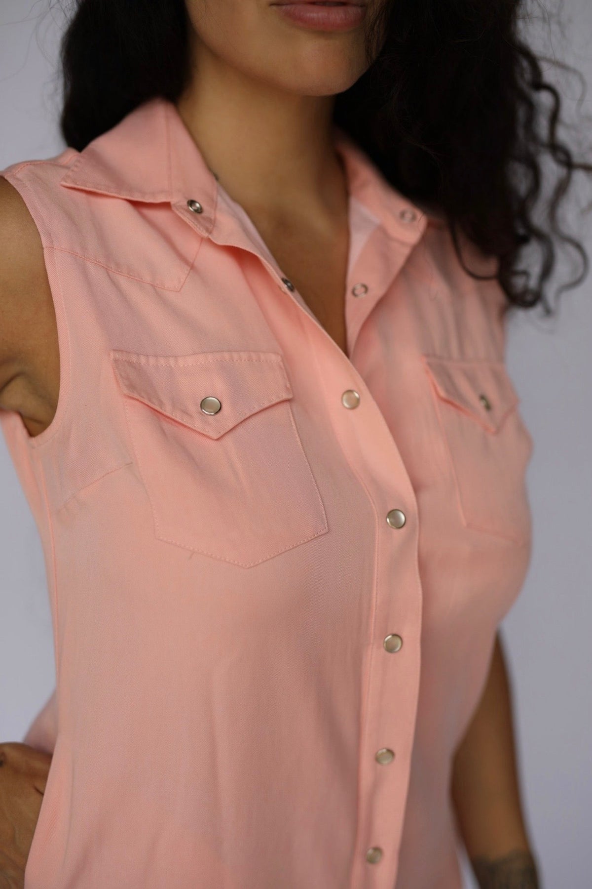 Close-up of the snap front and chest pockets on the H Bar C Palm Beach peach sleeveless shirt dress.