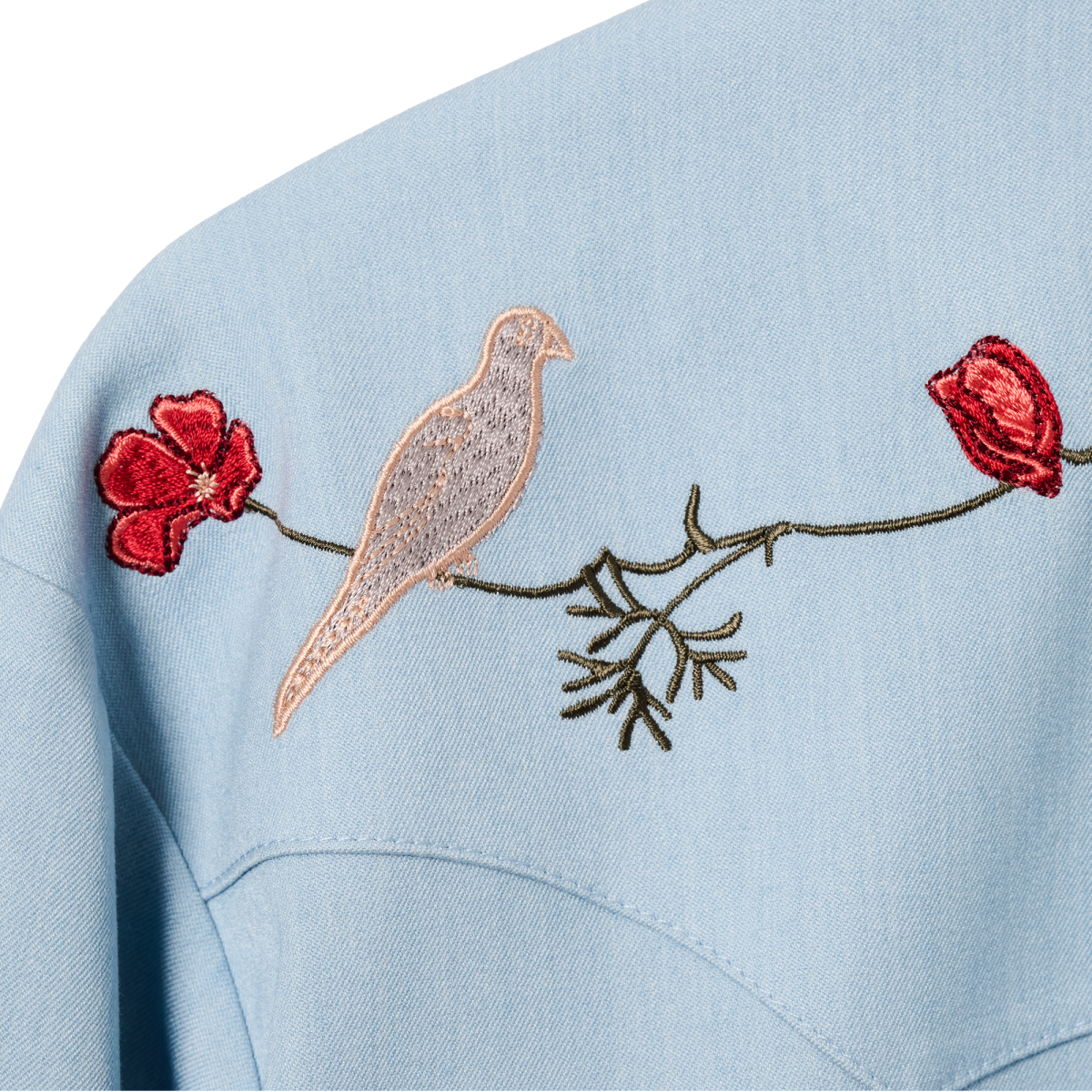 Embroidered dove and red poppies on the back of the HBarC x Gibson Dove shirt, inspired by the pickguard of the Gibson Dove guitar.