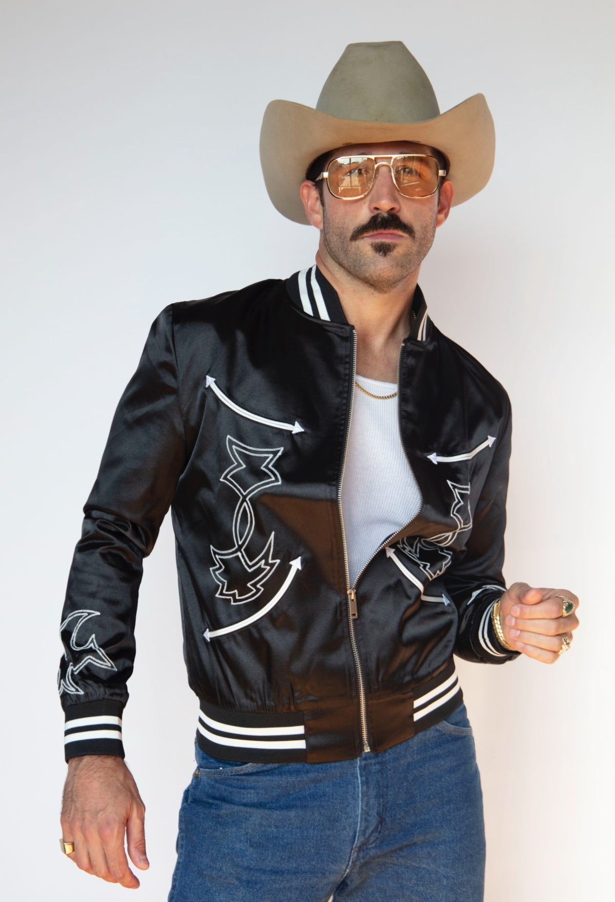 Front view of the H Bar C Odessa unisex black tour jacket worn with jeans and a cowboy hat.