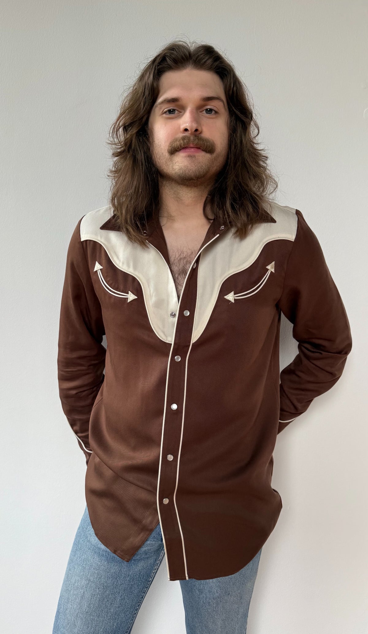 Man wearing the H Bar C San Juan men's chocolate brown pearl snap shirt with contrast off-white yoke.