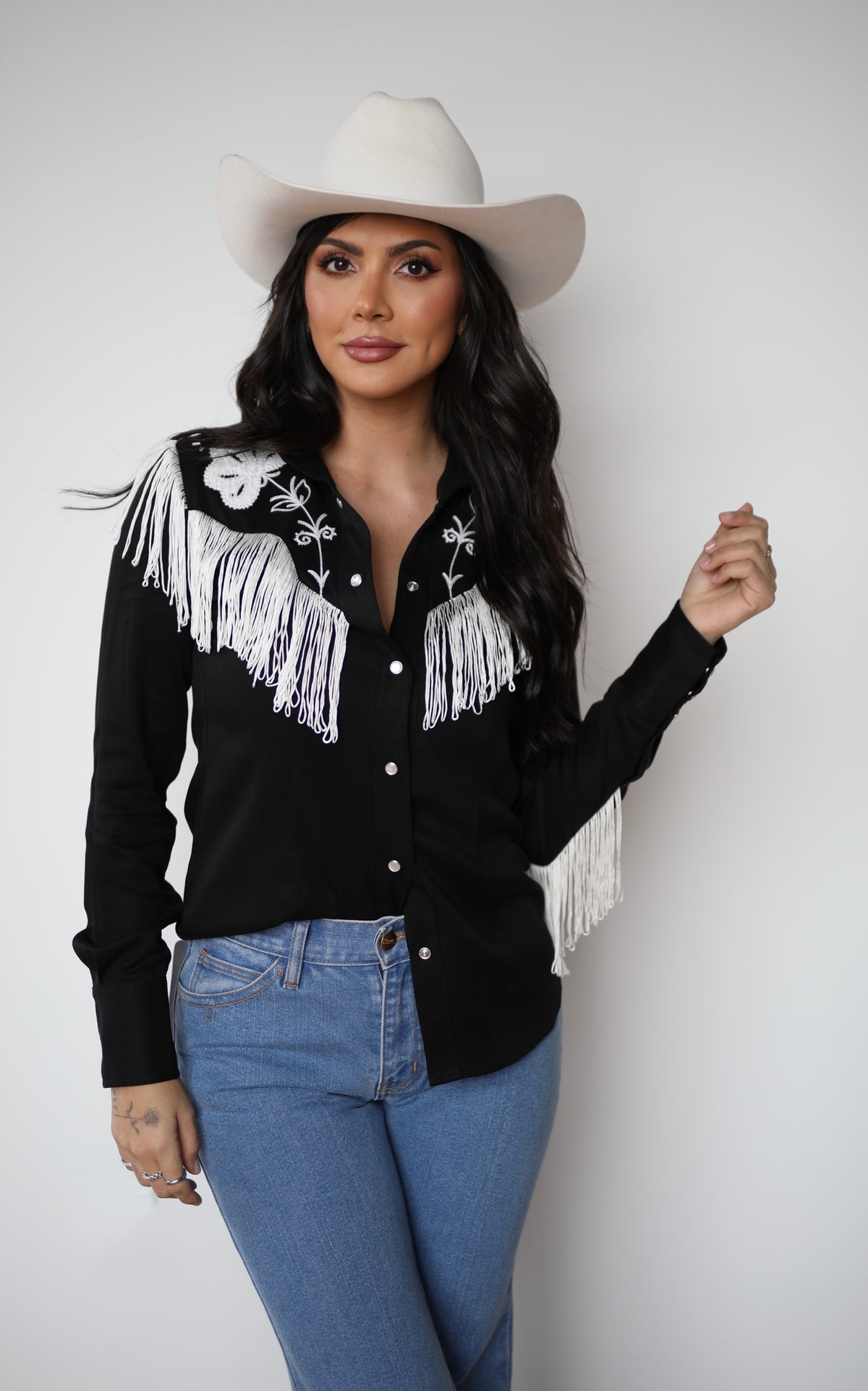 Front view of the H Bar C Taos women's black shirt with flowing white fringe on the yoke and sleeves.