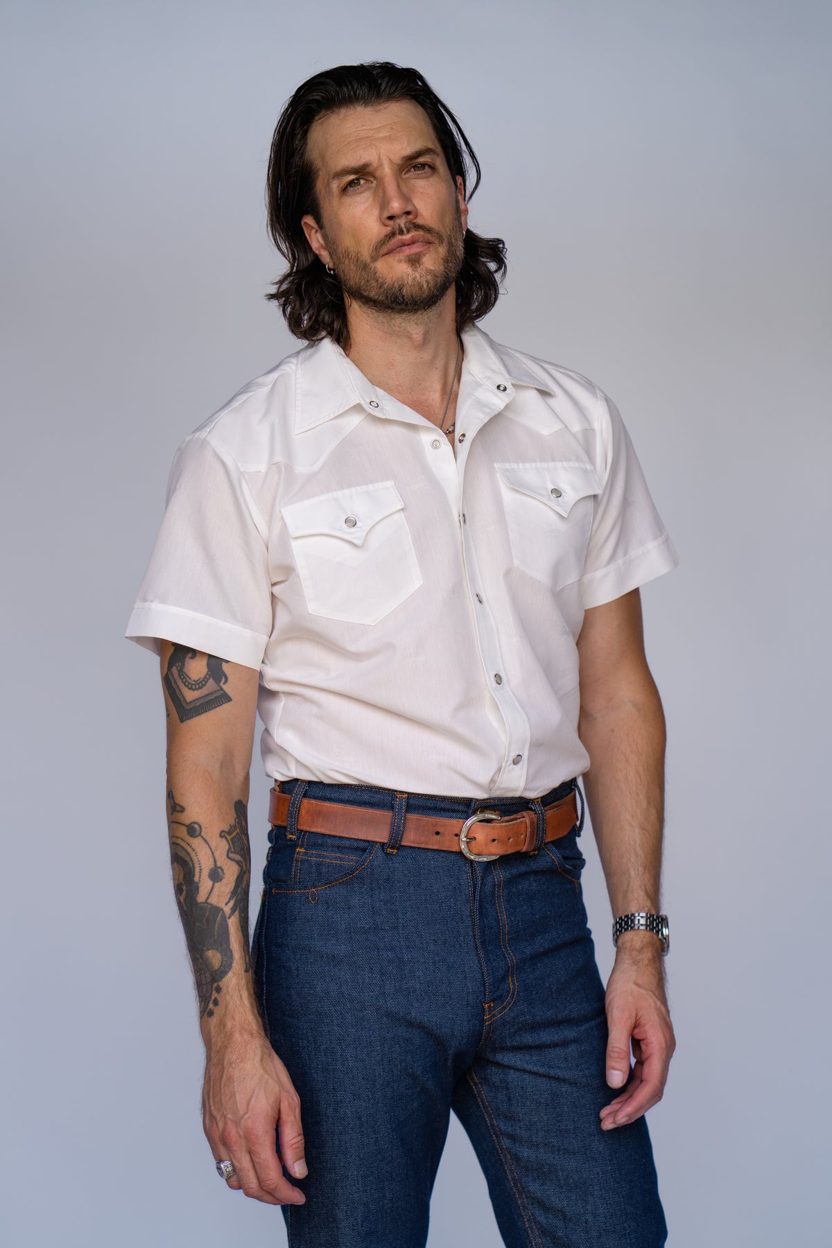 Man wearing the H Bar C Newport Jacquard short sleeve western shirt in white with a tonal horse jacquard pattern.