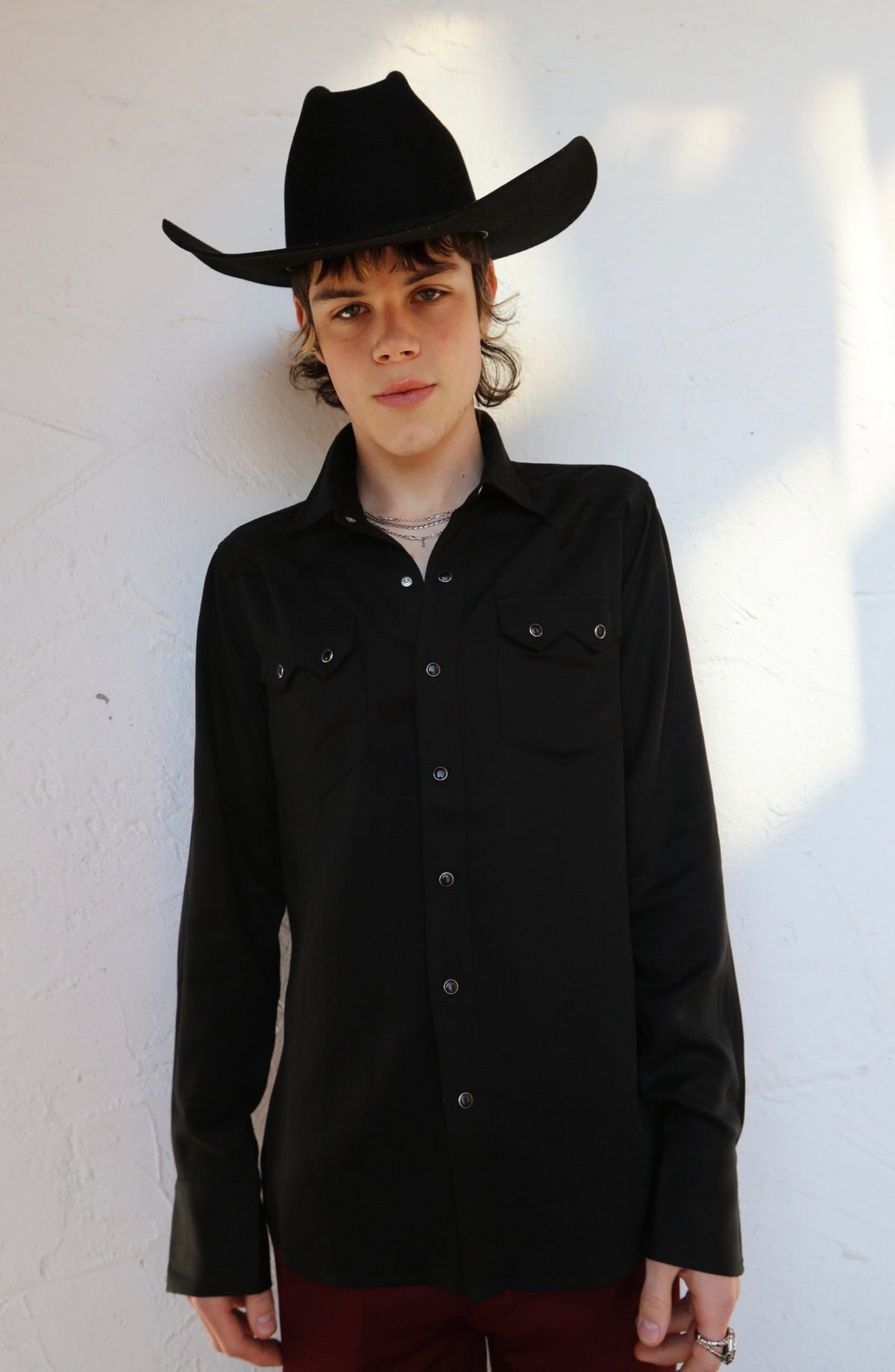Front view of the H Bar C Kansas City black western shirt worn with a black hat.