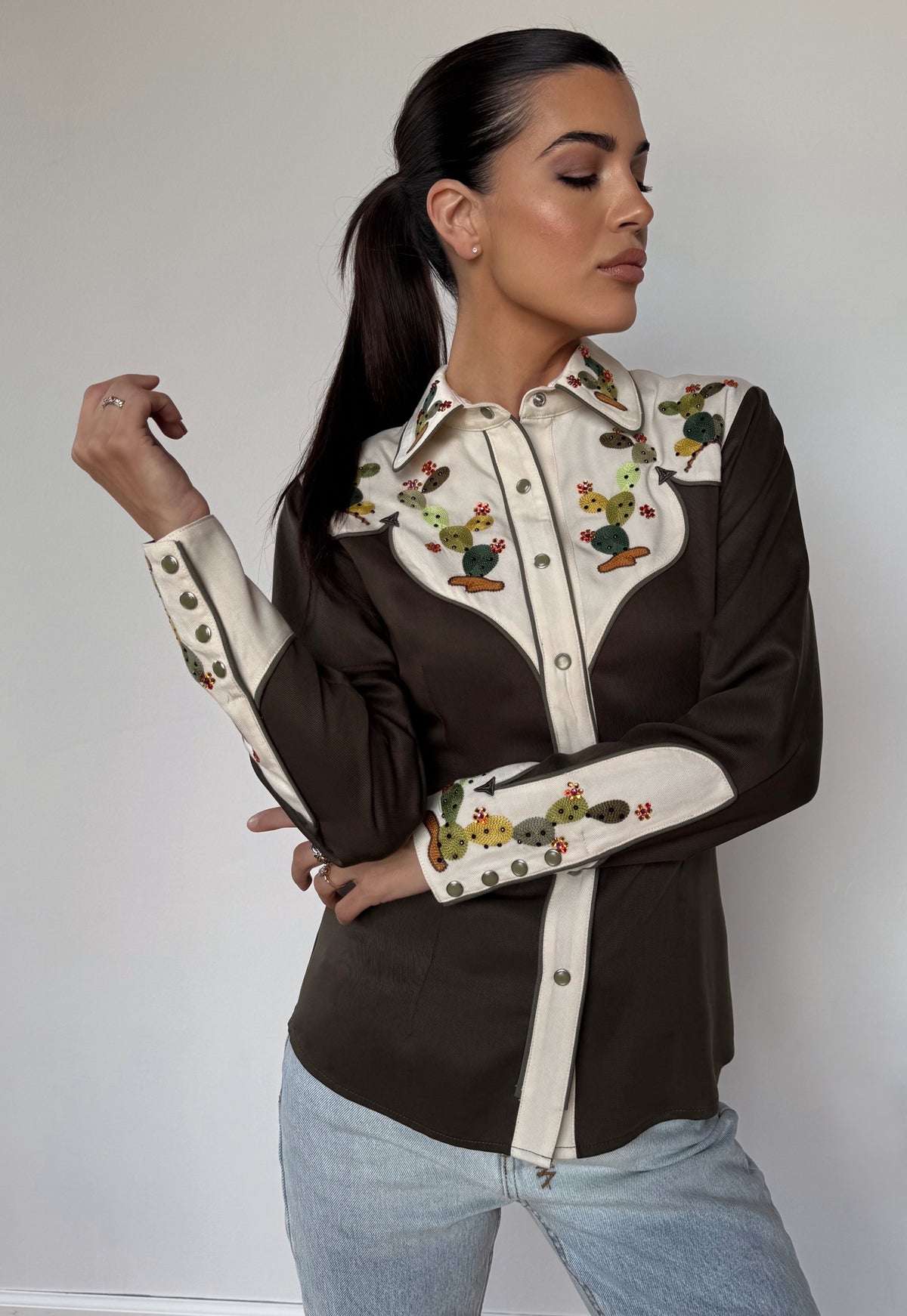 Three-quarter view of the H Bar C San Jose green western shirt with embroidered cream cuffs.