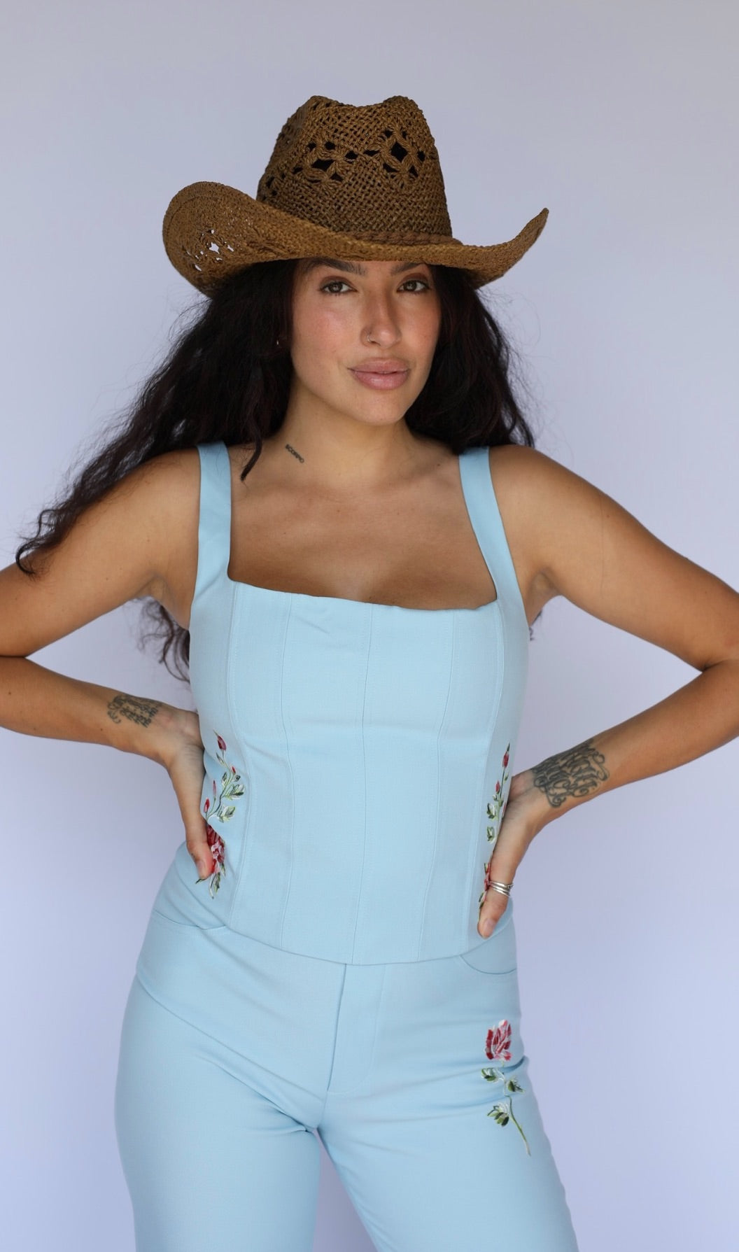 Woman with hands on hips in the H Bar C Abilene blue corset and matching western pants.