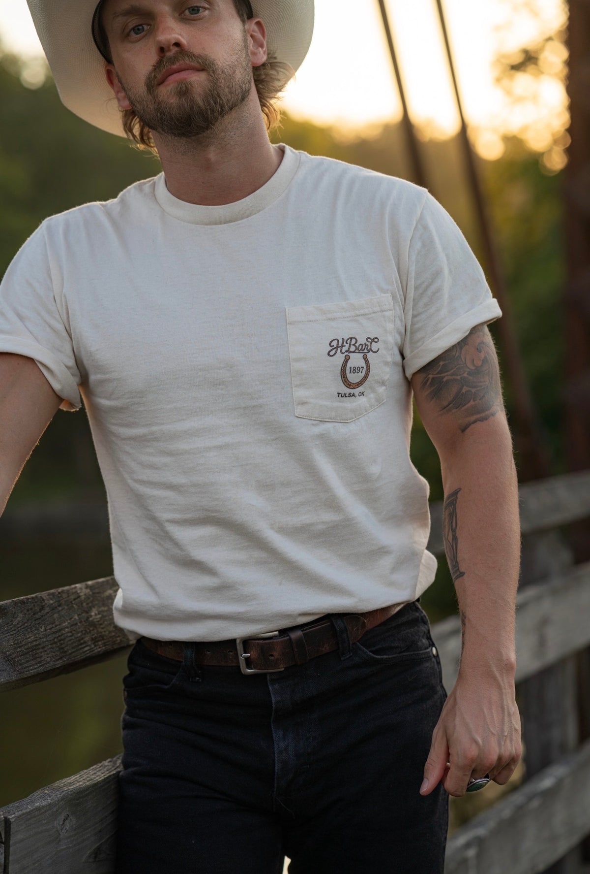 Front view of the cream H Bar C Tulsa Rope pocket tee, a Route 66 Centennial commemorative shirt.