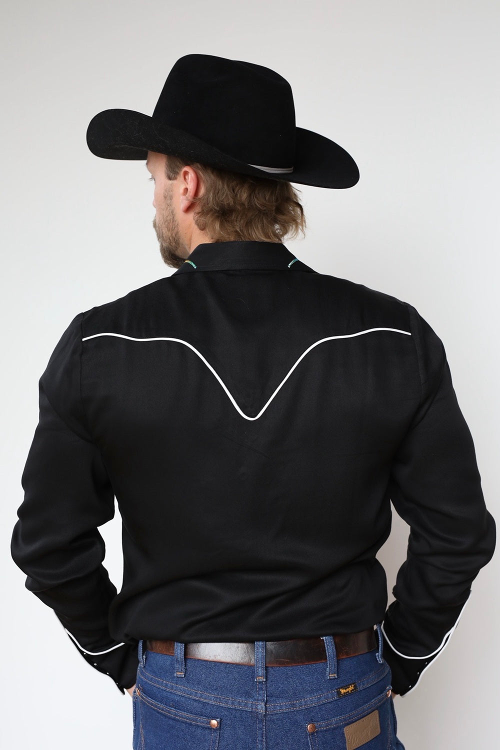 Back view of the H Bar C Texas black western shirt with white piped back yoke.