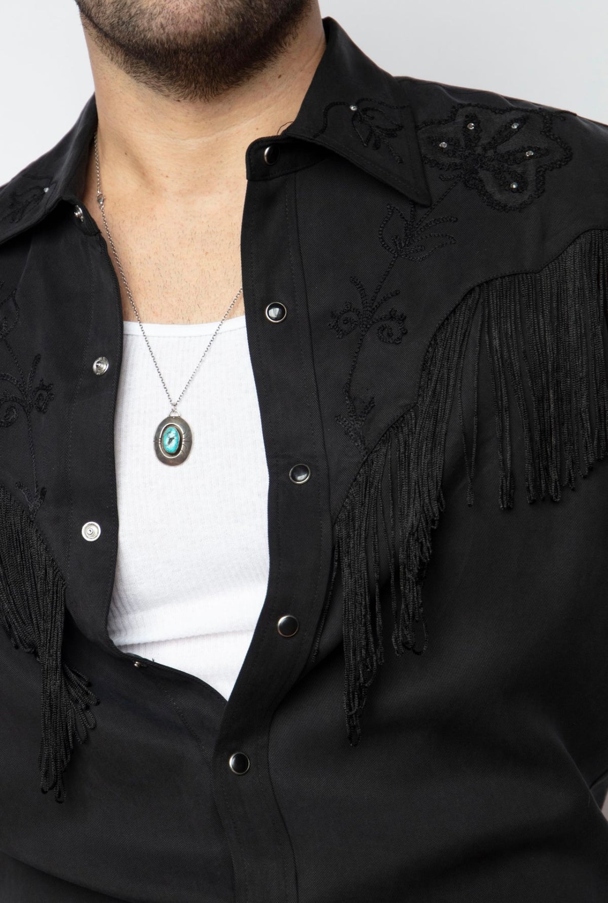 Close-up of the tonal black fringe and snap placket on the H Bar C Taos men's black shirt.