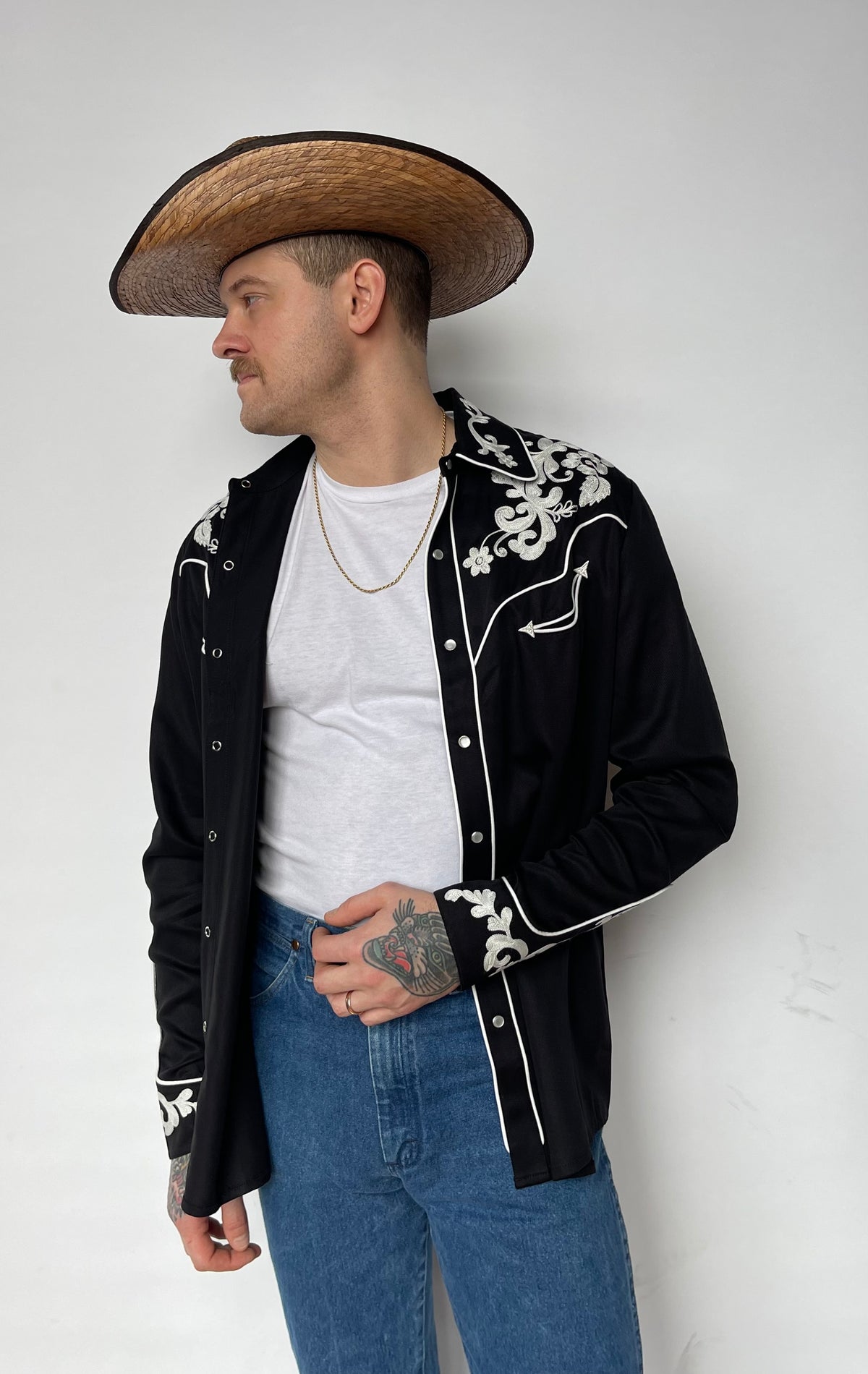 Side view of the H Bar C Durango black shirt worn open over a white tank.