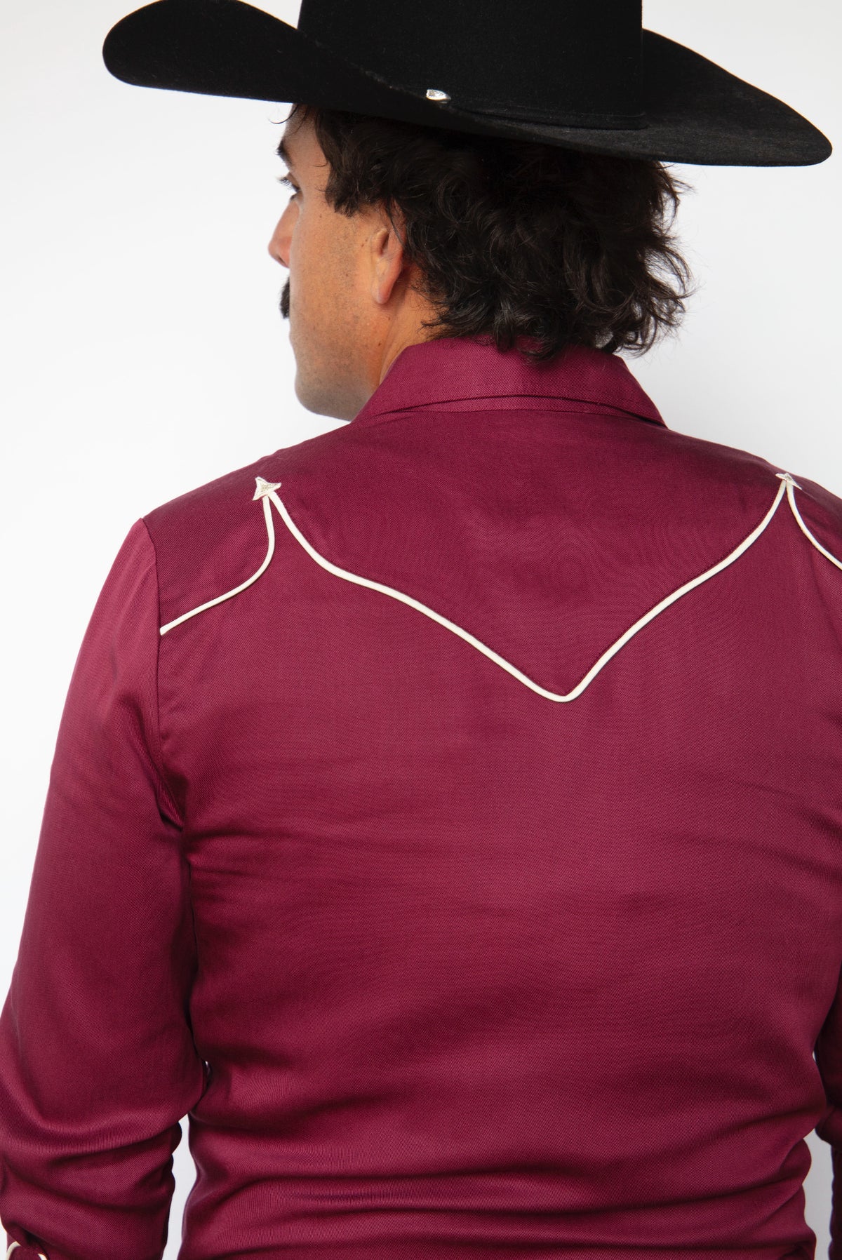 Back view of the H Bar C Reno maroon western shirt with a black cowboy hat.