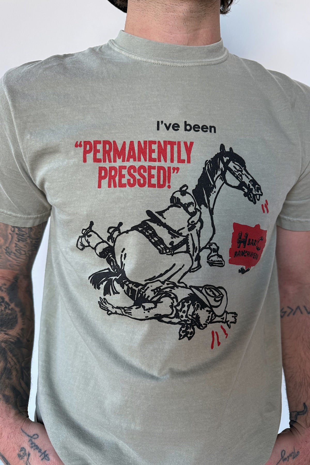 Close-up of the Permanently Pressed horse graphic on the H Bar C Dry Gulch olive T-shirt.