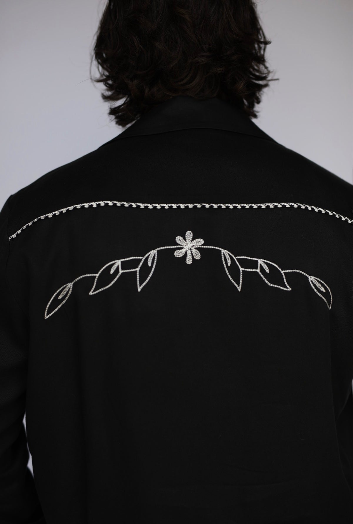 Close-up of the embroidered back yoke on the H Bar C Bolero Nogales black jacket.