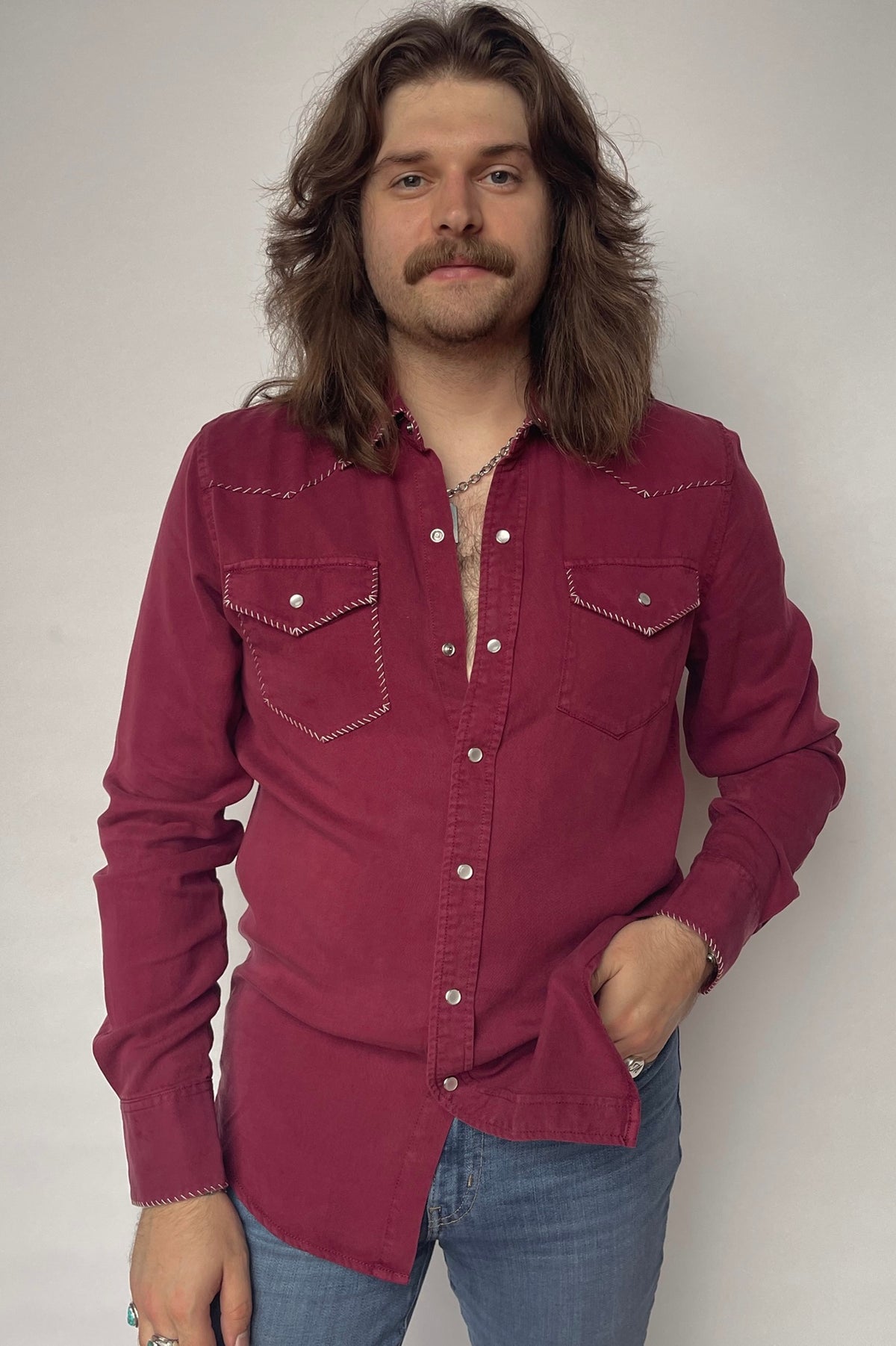 Front view of the H Bar C Brooklyn wine red snap shirt with stitched one point yoke, worn with jeans.