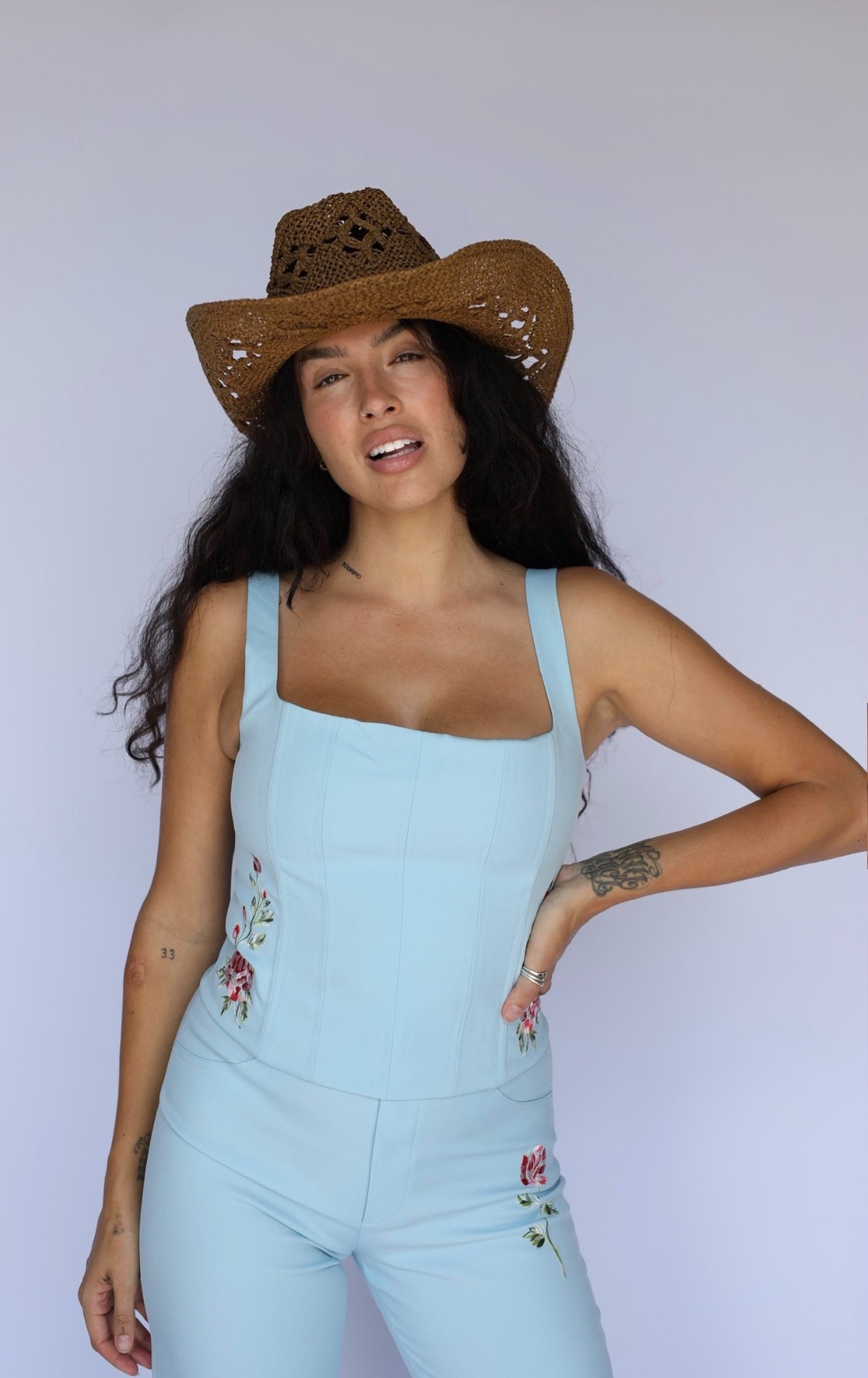 Front view of the H Bar C Abilene light blue corset set with a straw cowboy hat.