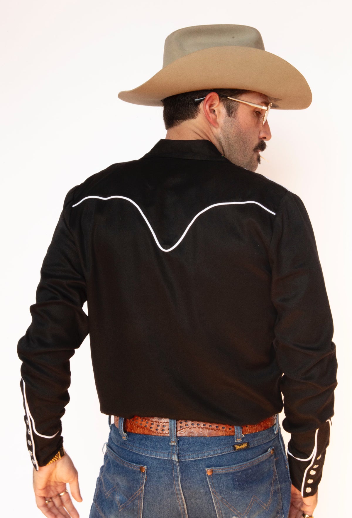 Back view of the H Bar C Arrowhead black western shirt with white piped back yoke.