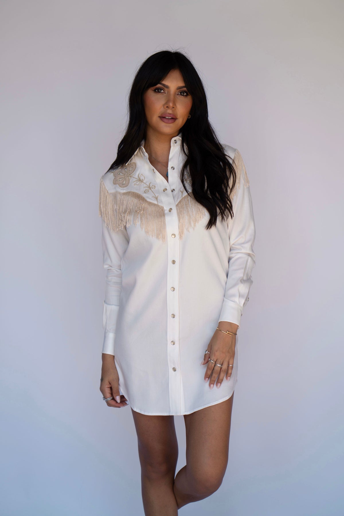 Model in the H Bar C Roswell long sleeve white fringe shirt dress.