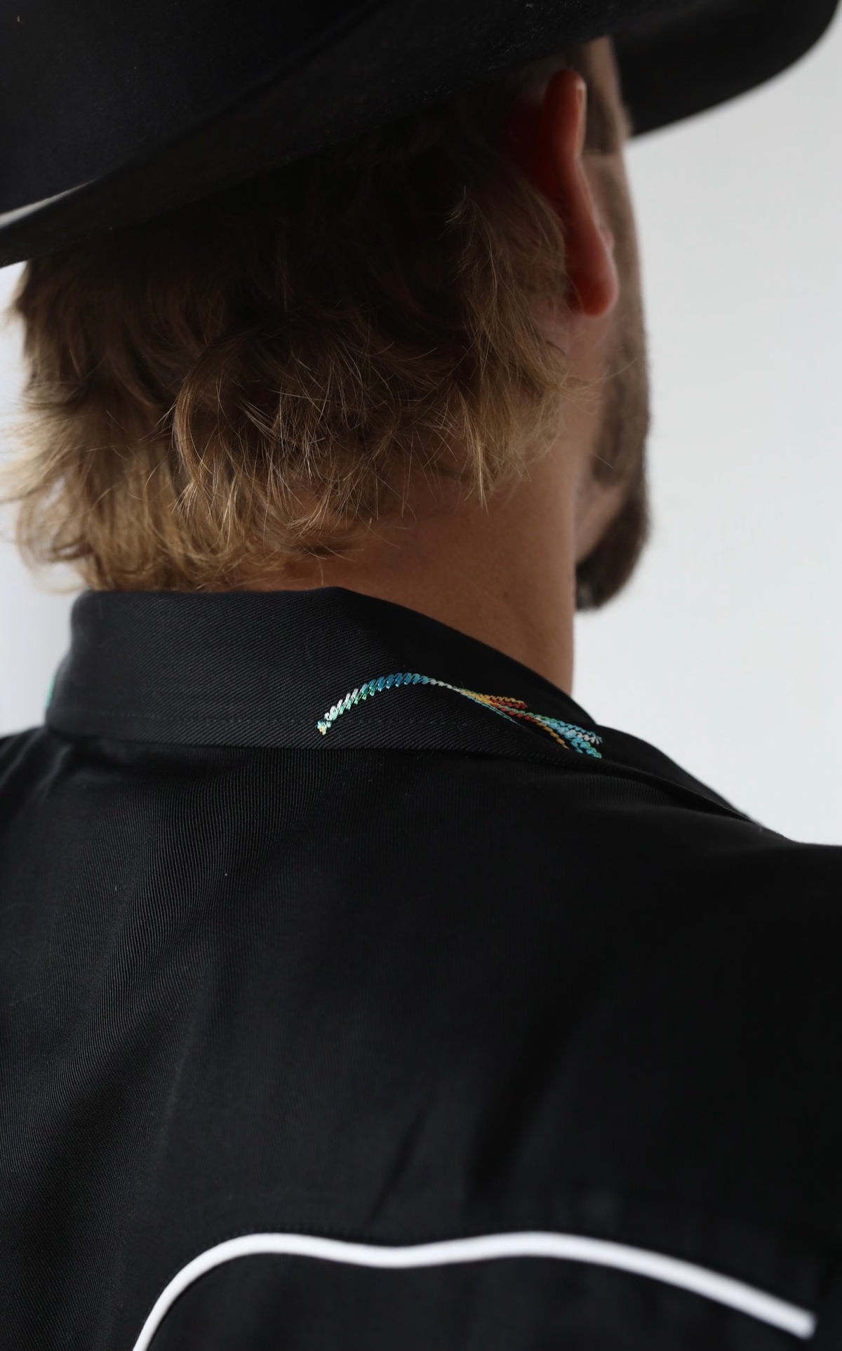 Back yoke close-up of the H Bar C Texas black shirt with white piping.