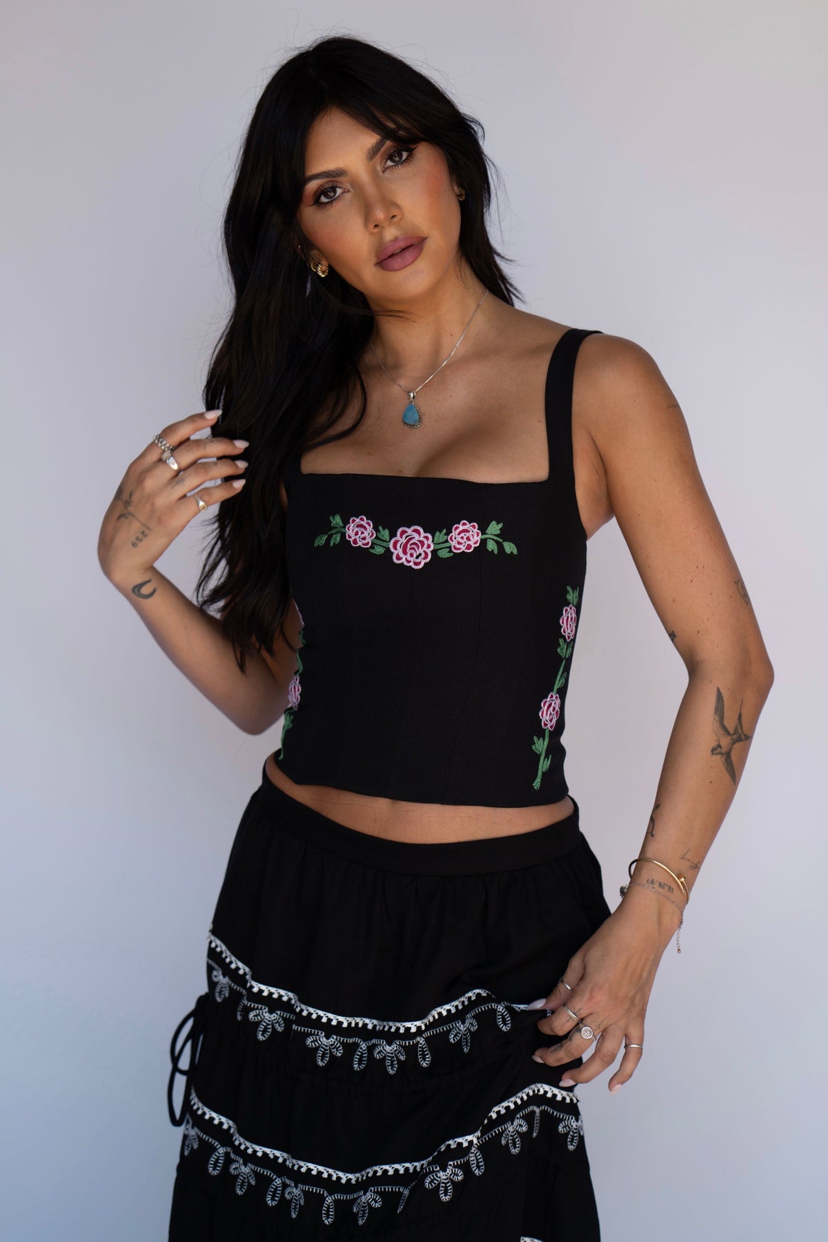 Model in the H Bar C Canterbury corset, a structured black western corset top with embroidered roses.