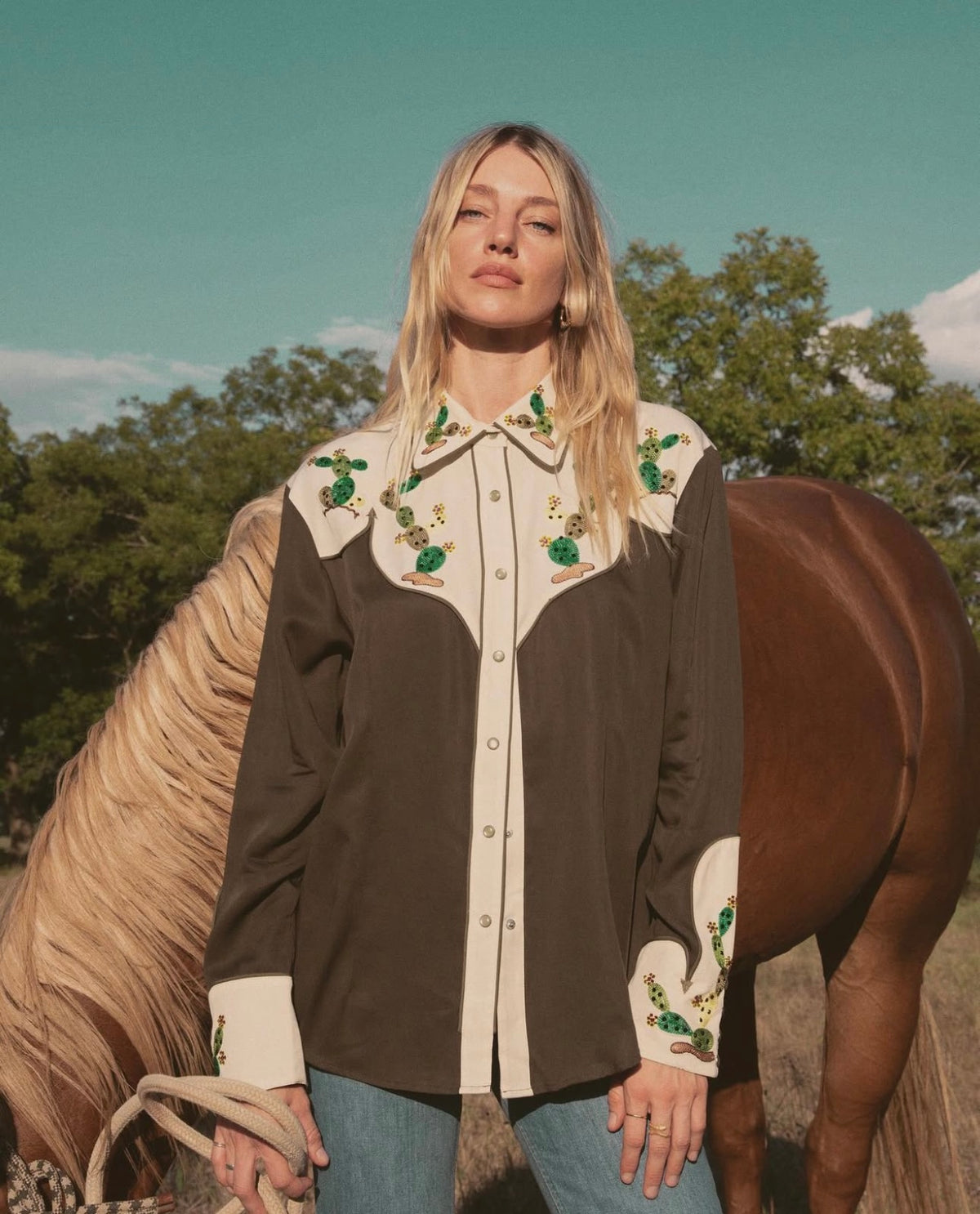 Woman beside a horse wearing the H Bar C San Jose women's green and cream western shirt.