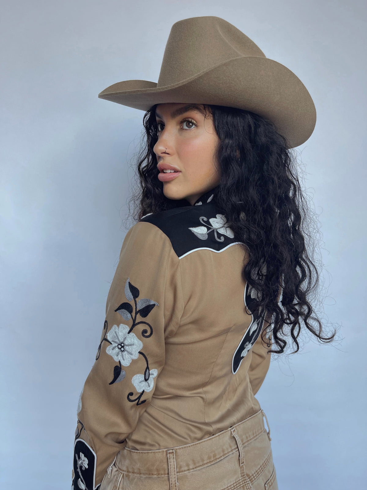 Side view of the H Bar C Santa Ana women's tan shirt with embroidered sleeves.