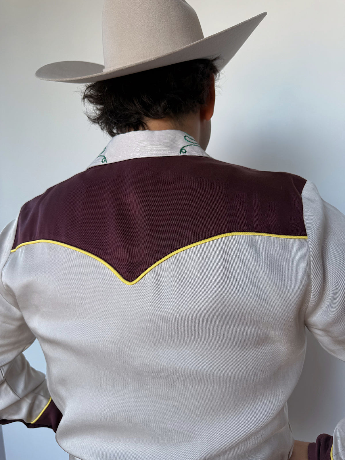Back yoke of the H Bar C Cowboy Bob shirt in maroon with yellow piping.