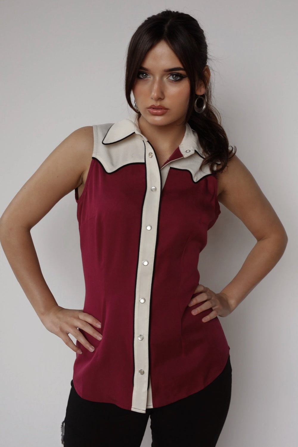 Woman wearing the H Bar C Atlanta women's sleeveless shirt in wine with an off white western yoke, made of Tencel.