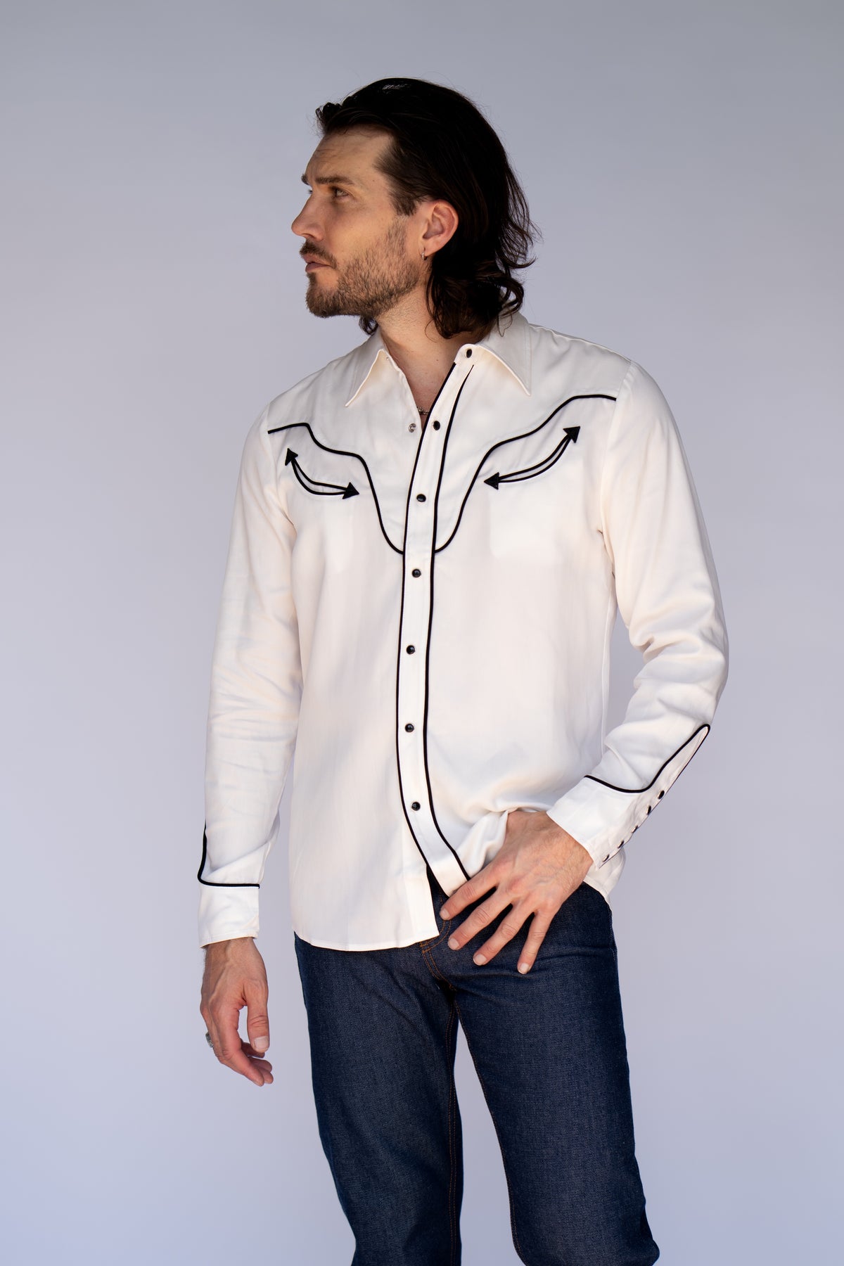 Three-quarter view of the H Bar C San Fernando white and black piped pearl snap shirt.