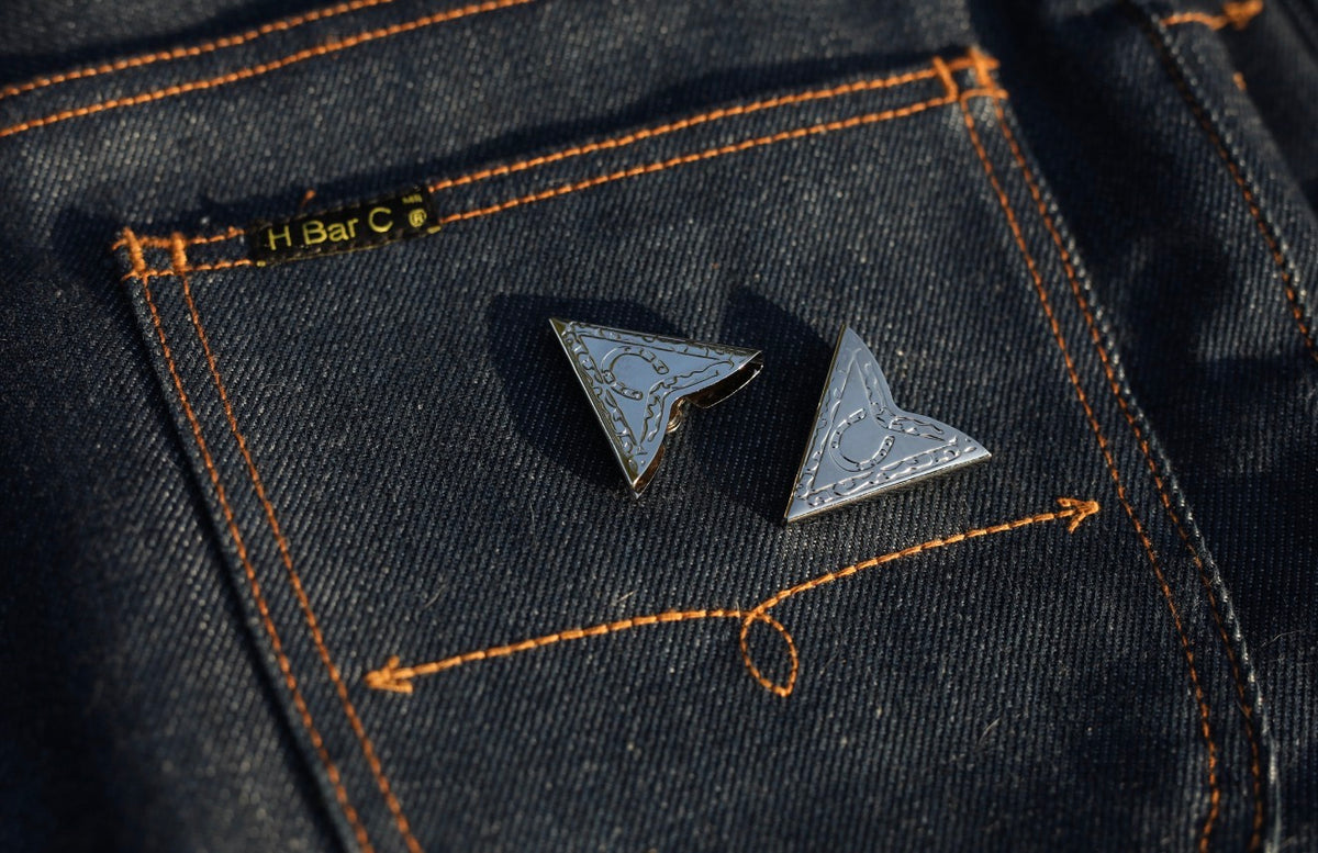 H Bar C engraved collar tips on the back pocket of H Bar C indigo jeans.