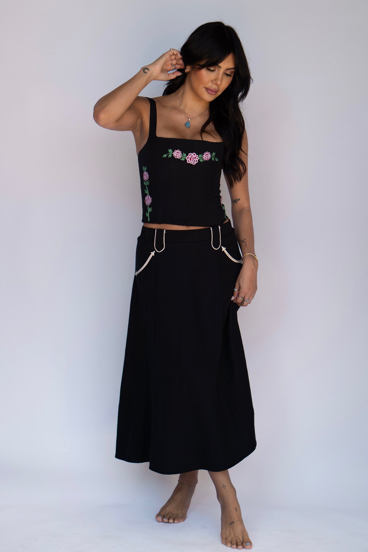 Model in the H Bar C Santa Fe black skirt with contrasting white piping, styled with an embroidered black corset.