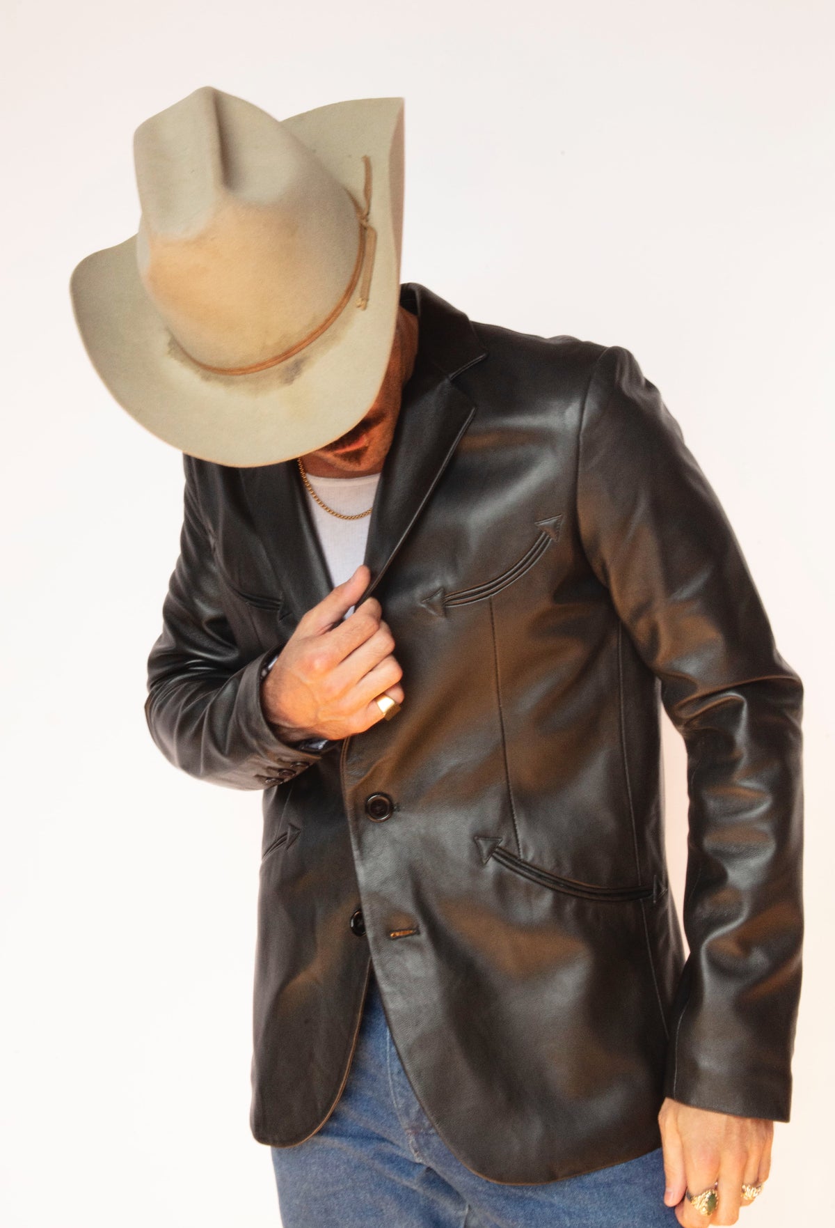 Man tipping his hat in the H Bar C Carson black lambskin western jacket.