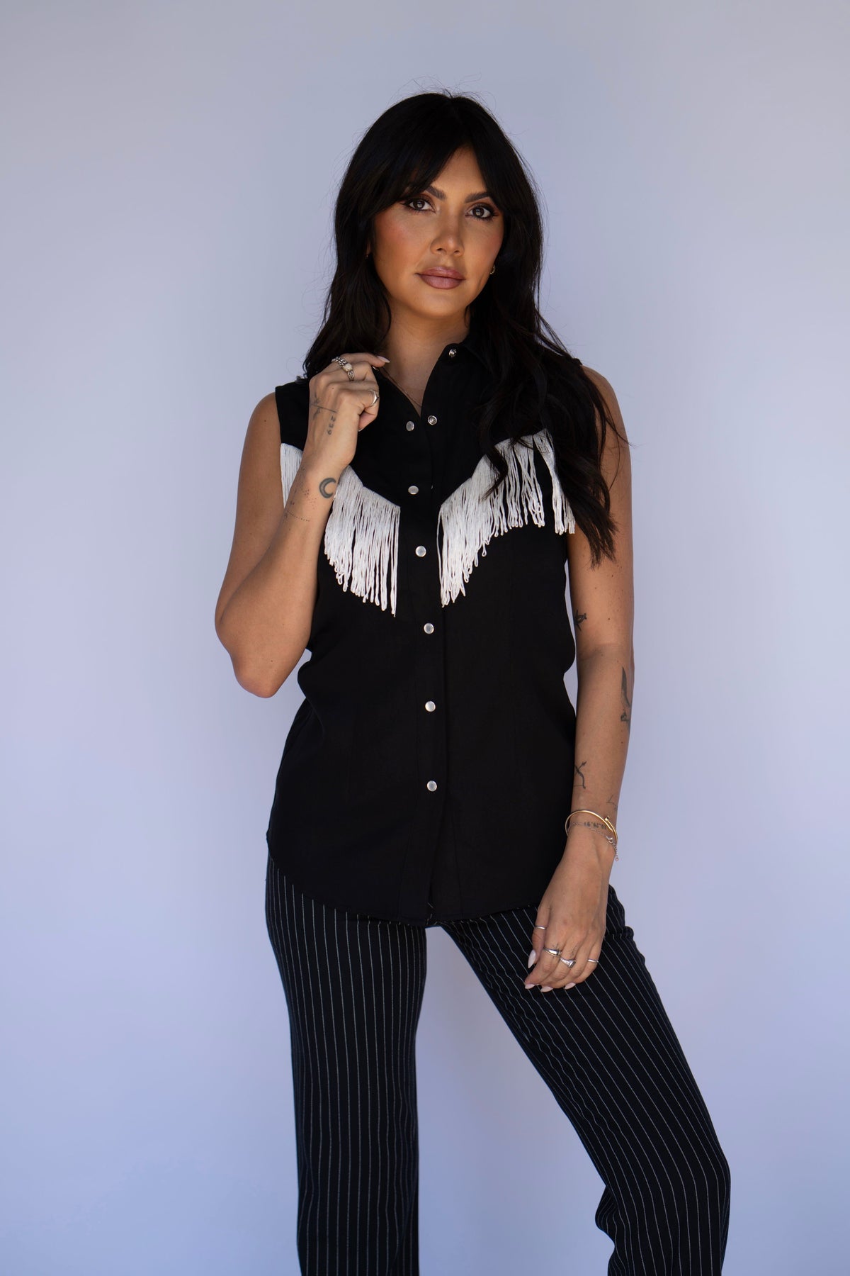 Model in the H Bar C Tulsa sleeveless black western shirt with white fringe.
