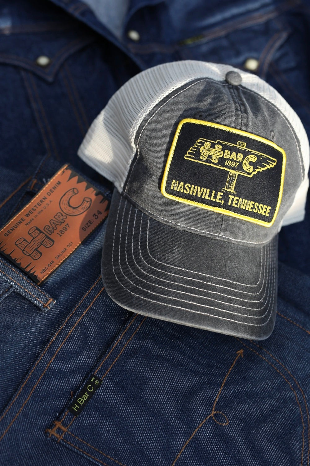 H Bar C TN Signpost mesh trucker hat in black with a yellow Nashville, Tennessee signpost patch.